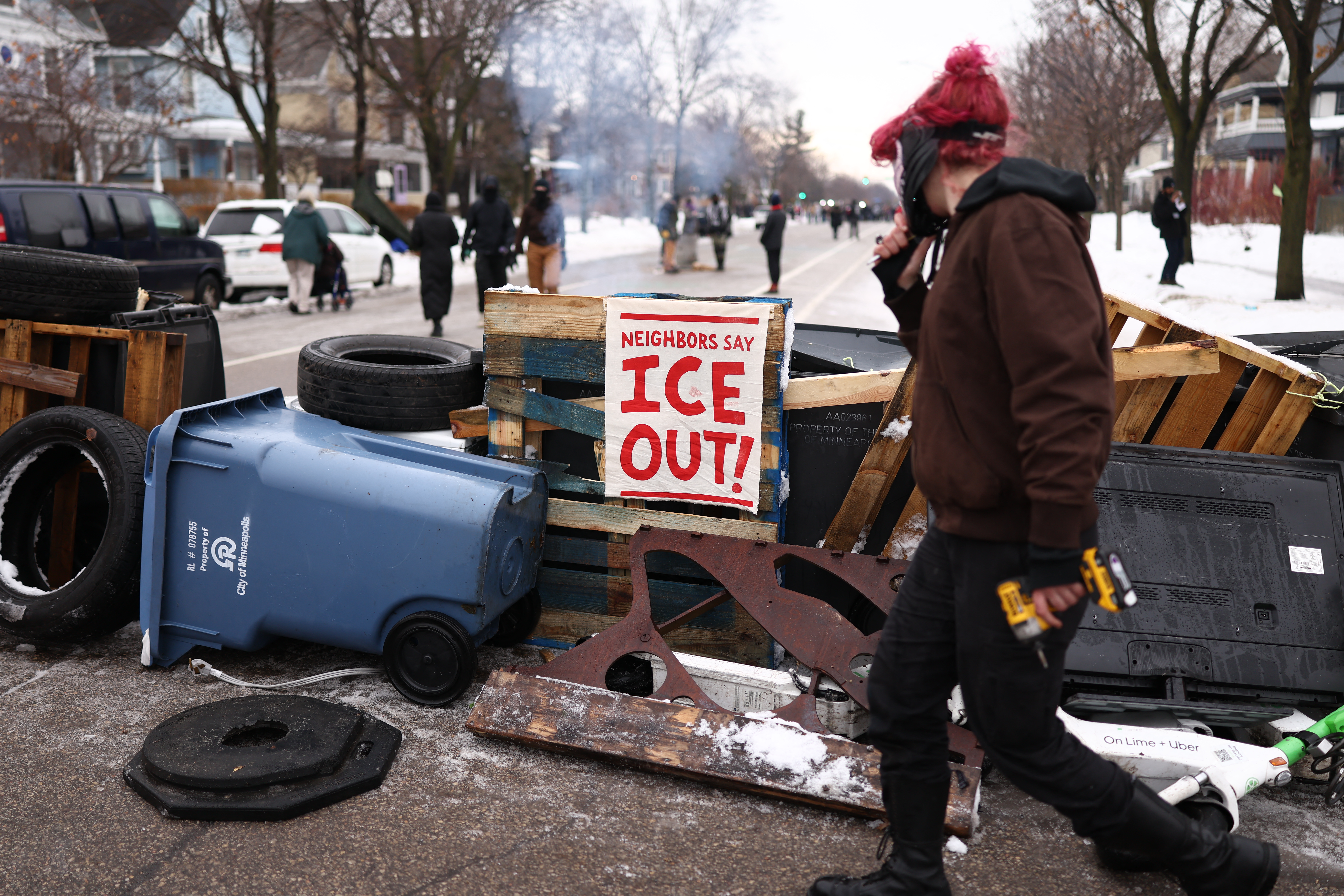 Demonstrators gather at the street where 37-year-old Renee Nicole Good was shot and killed at point blank range on January 7 by a US Immigration and Customs Enforcement (ICE) agent as she apparently tried to drive away from agents who were crowding around her car, in Minneapolis, Minnesota, on January 8, 2026.