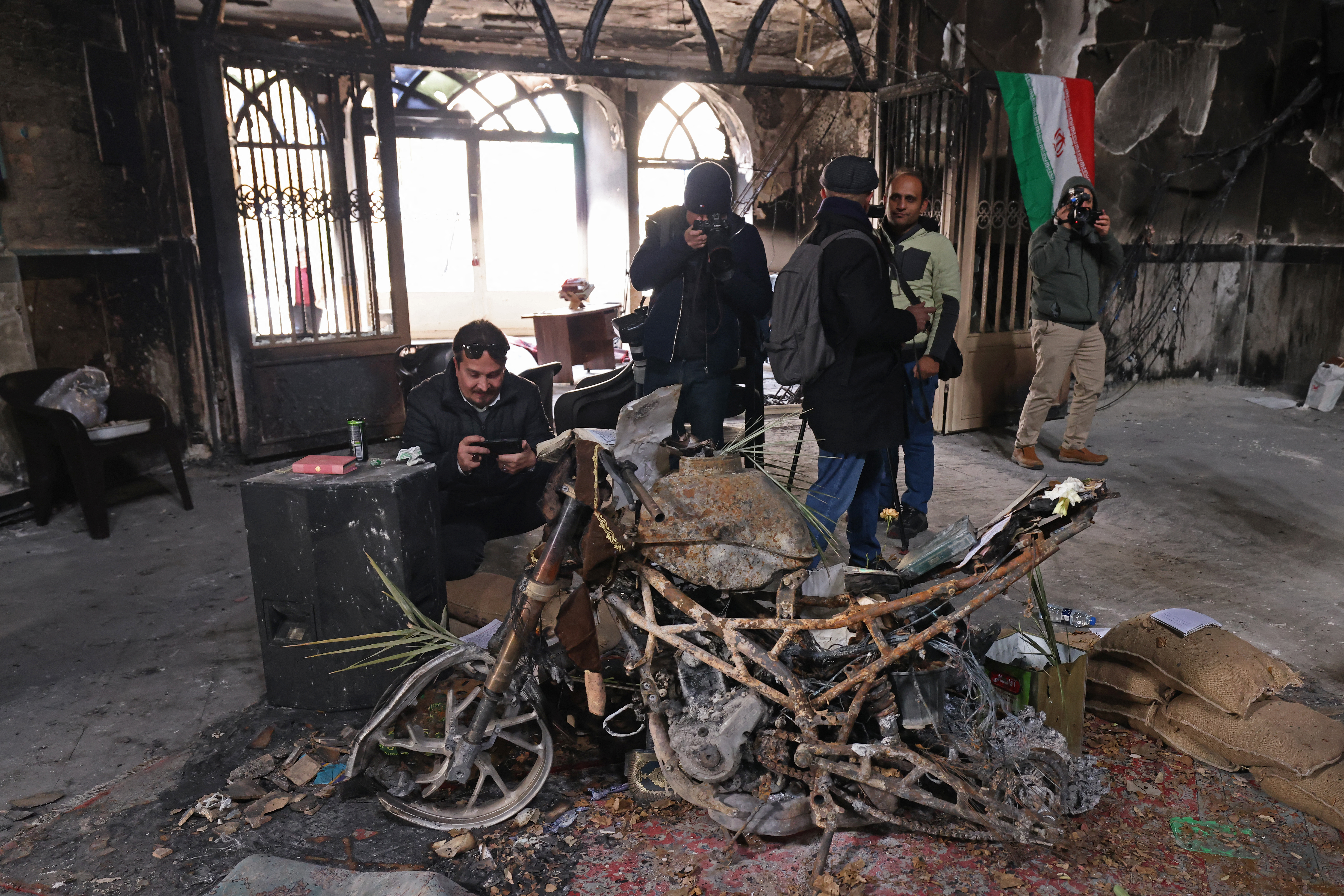 This photograph taken during a tour for foreign media shows media representatives visiting the Beheshti Mosque that was damaged during recent public protests, in Tehran on January 21, 2026.