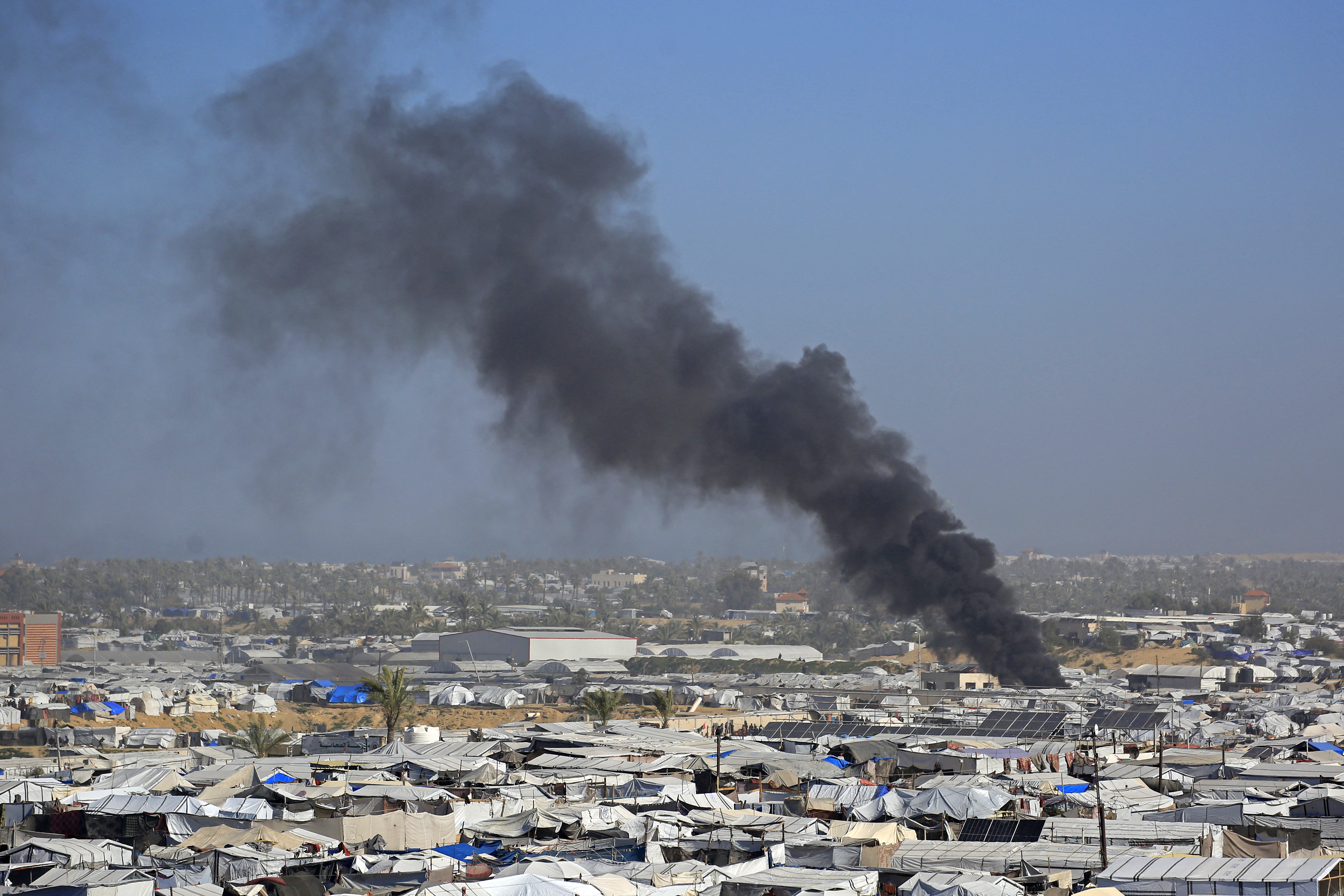 Smoke rises from the Gath shelter, housing displaced Palestinians, after an Israeli air strike in the west of Khan Yunis, southern Gaza Strip on January 31, 2026.