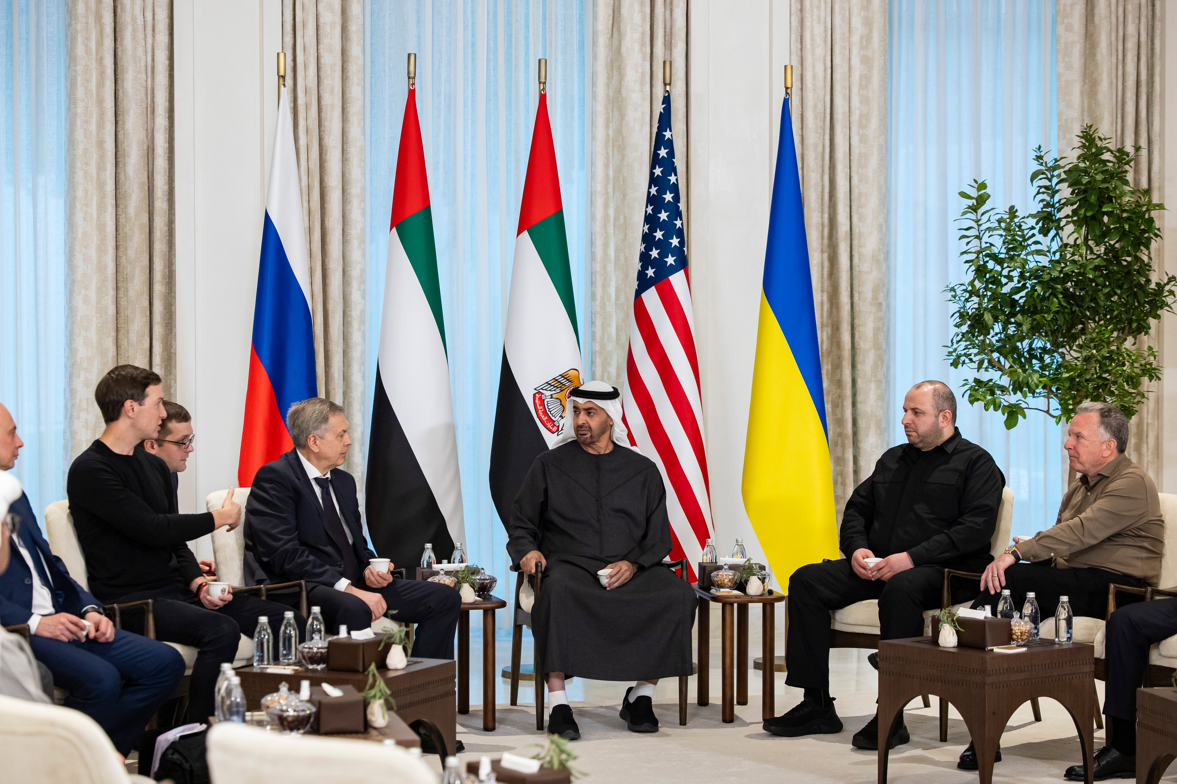 Emirati, US, Ukrainian and Russian officials sit in negotiations.