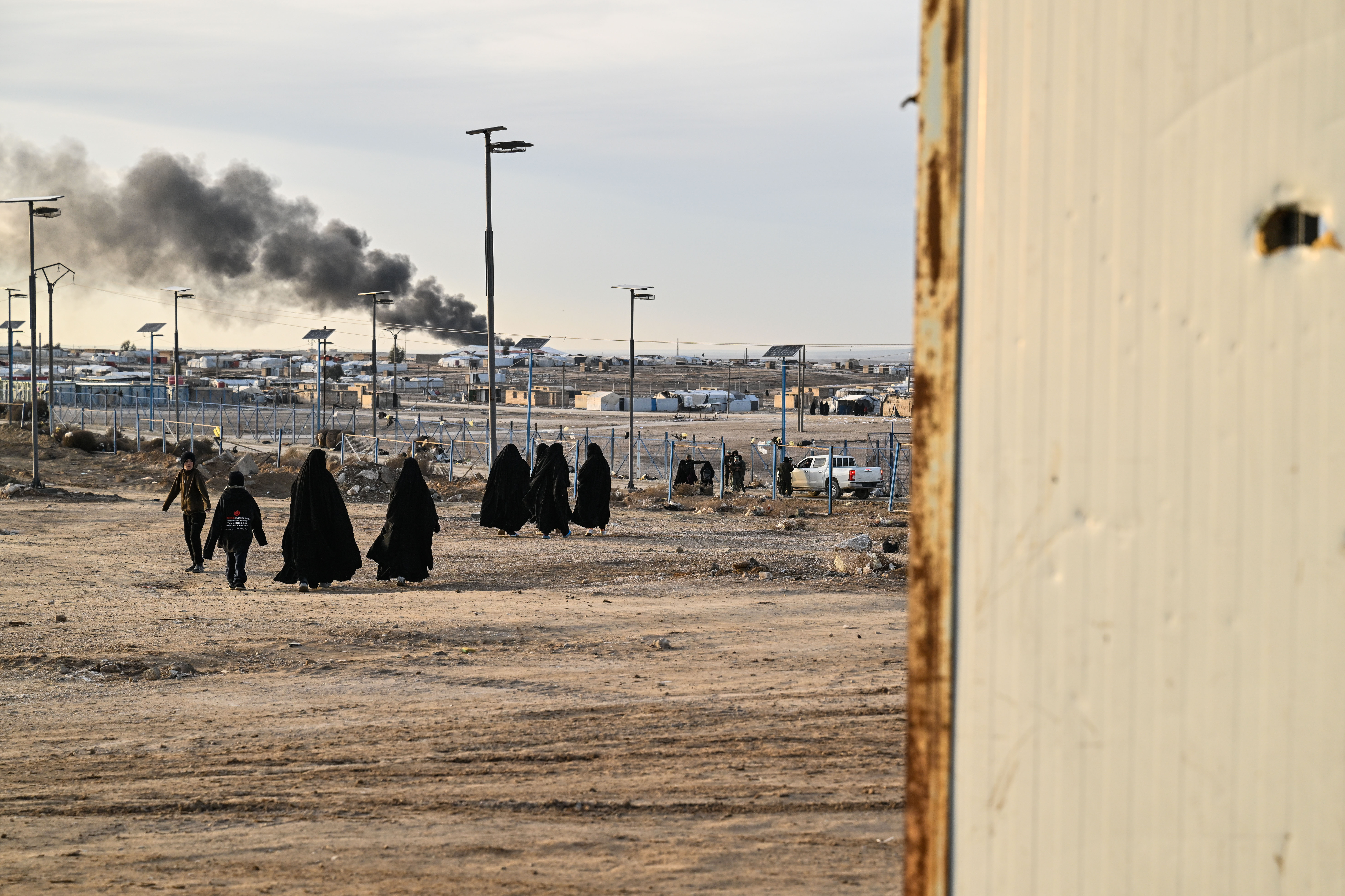 AL HASAKAH, SYRIA - JANUARY 21: Women and children seen inside Al-Hol camp in Hasakah province that houses around 24,000 people, amongst them some 6,200 women and children from around 40 nationalities, and including relatives of suspected Islamic State jihadists, after Kurdish forces withdrew from the site on January 21, 2026 in Al Hasakah, Syria. Syrian government forces have taken control over large swaths of northeast Syria amid clashes with the Kurdish-led Syrian Democratic Forces (SDF). In Al Hasakah governate, government forces have taken control of the infamous Al-Hol (Al-Hawl) camp, previously controlled by the SDF, that houses families accused of having links to Islamic State fighters. (Photo by Abdulmonam Eassa/Getty Images)