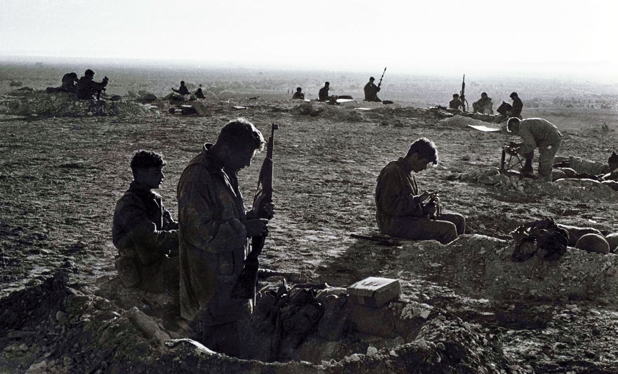 Israeli soldiers in foxholes as they clean their light weapons at a base at the Milta Pass during Operation Kadesh in the 1956 Middle East war. In October 1956 Israel, under continued cross border commando raids from Egypt, crossed into the Sinai in an audacious plan to take control of the Suez Canal with France and Britain. As a result America was forced into a crisis with its closest European allies, and Israel seized control of the Gaza Strip. [Reuters]