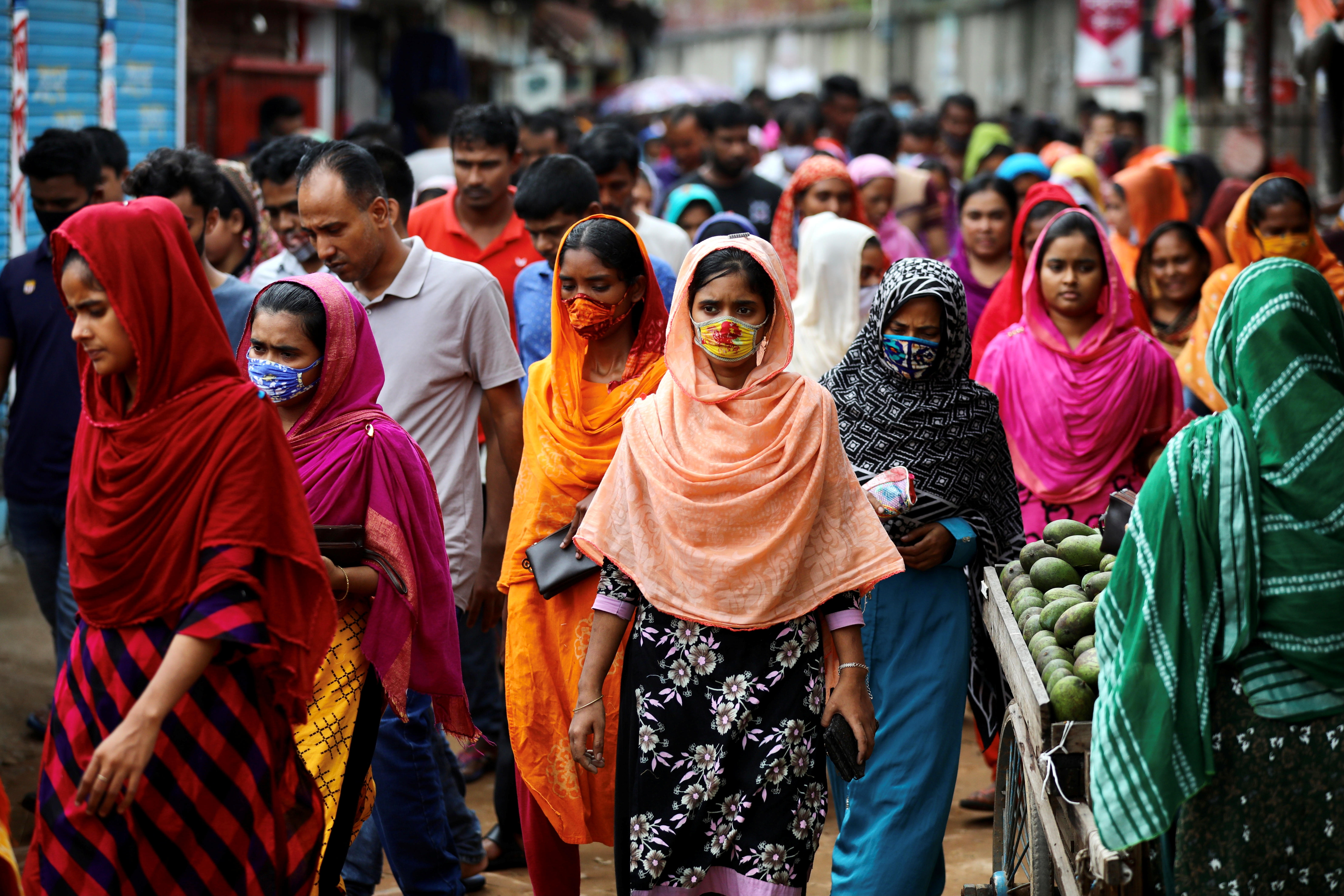 Garment workers come out of a factory during the lunch break as factories remain open despite a countrywide lockdown, in Dhaka, Bangladesh, July 6, 2021. REUTERS/Mohammad Ponir Hossain