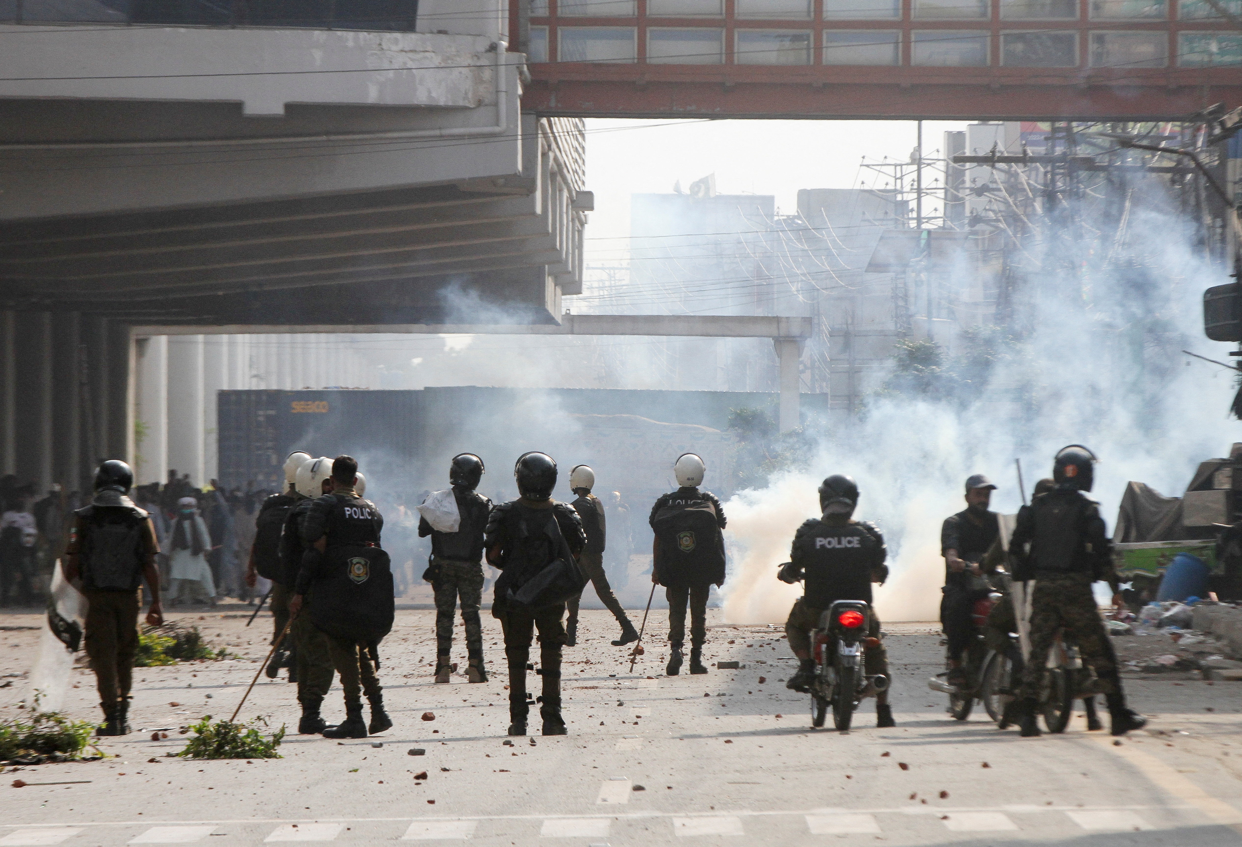 Police officers stand as they use tear gas to disperse supporters of Tehreek-e-Labbaik Pakistan (TLP) during a solidarity march for Gaza in Lahore, Pakistan, October 10, 2025. REUTERS/Mohsin Raza