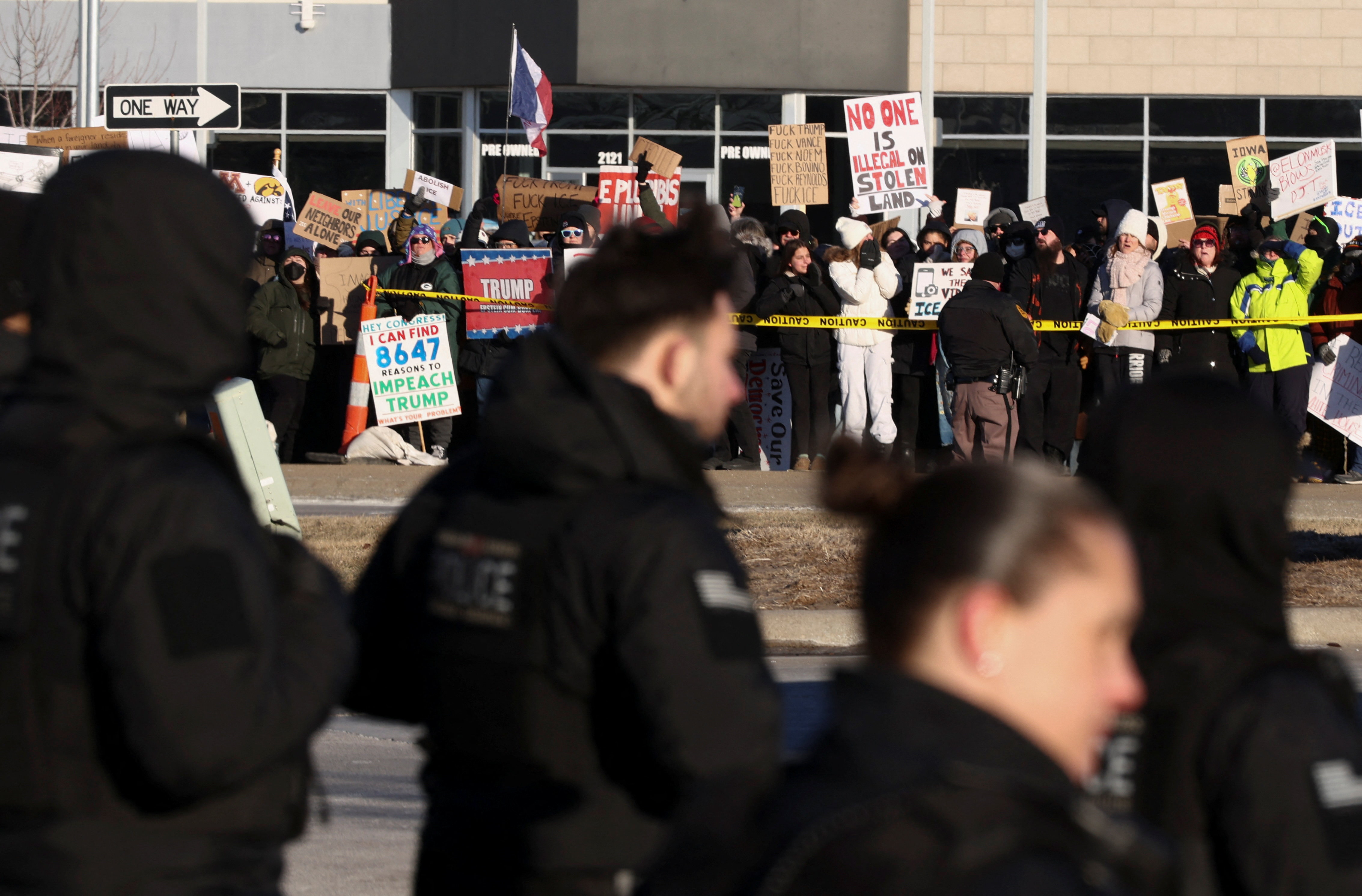 Protesters line up outside a Trump rally in Clive, Iowa
