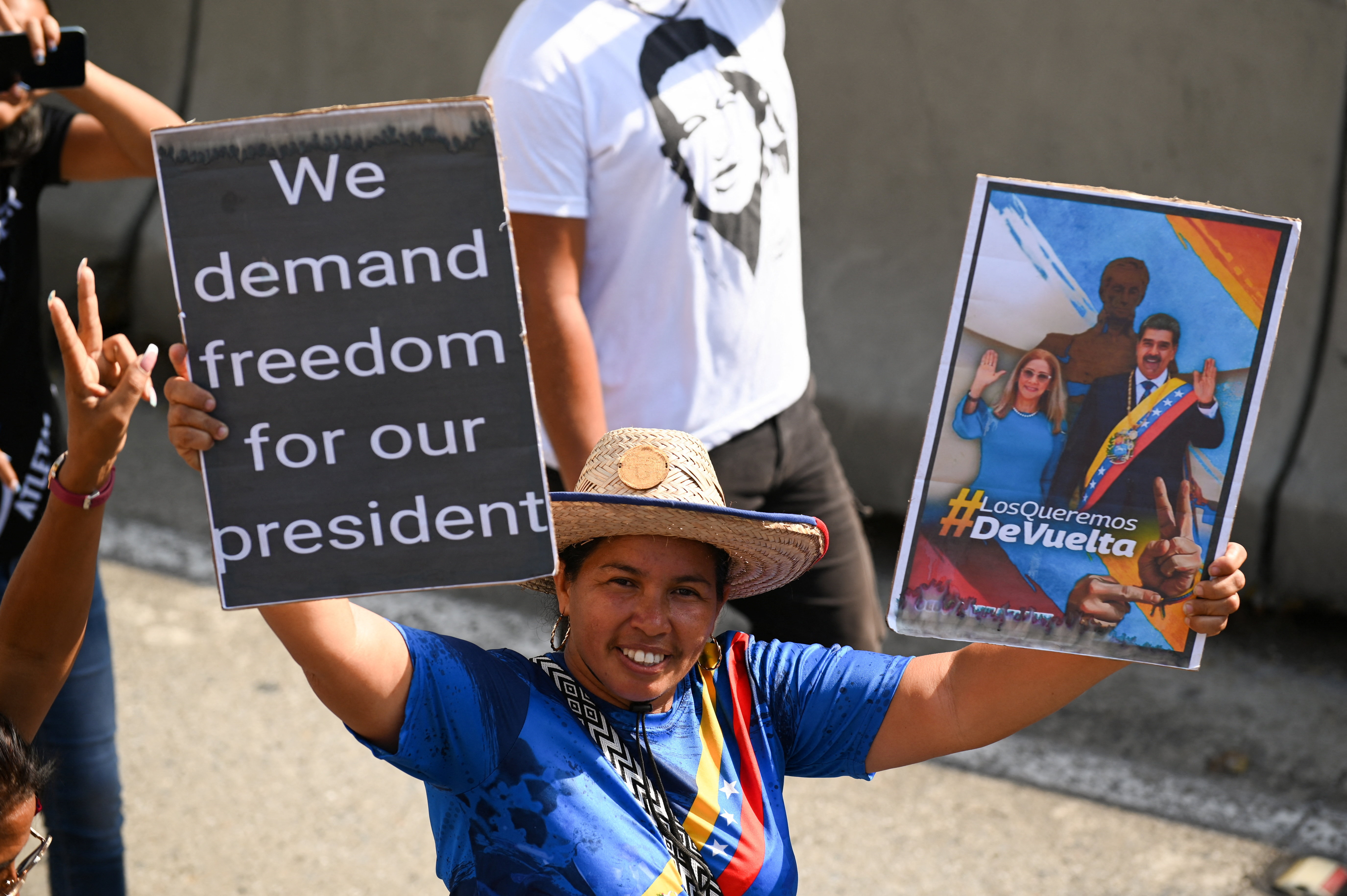 A supporter of Venezuela's government holds placards during a rally to demand the release of ousted President Nicolas Maduro and his wife, Cilia Flores, one month after their capture by the U.S. during recent U.S. strikes on the country, in Caracas, Venezuela, February 3, 2026. REUTERS/Maxwell Briceno