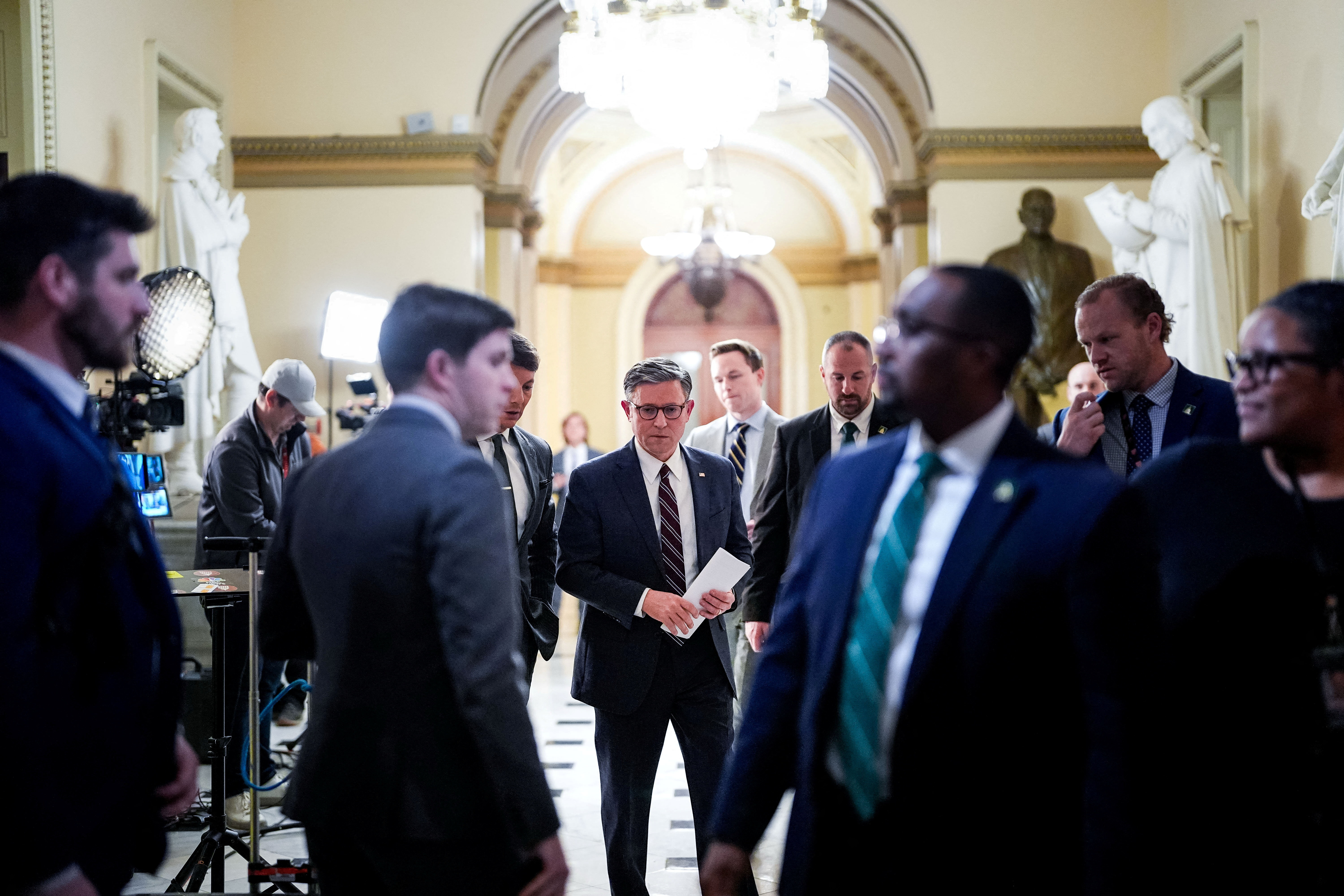 Mike Johnson stands in the halls of Congress