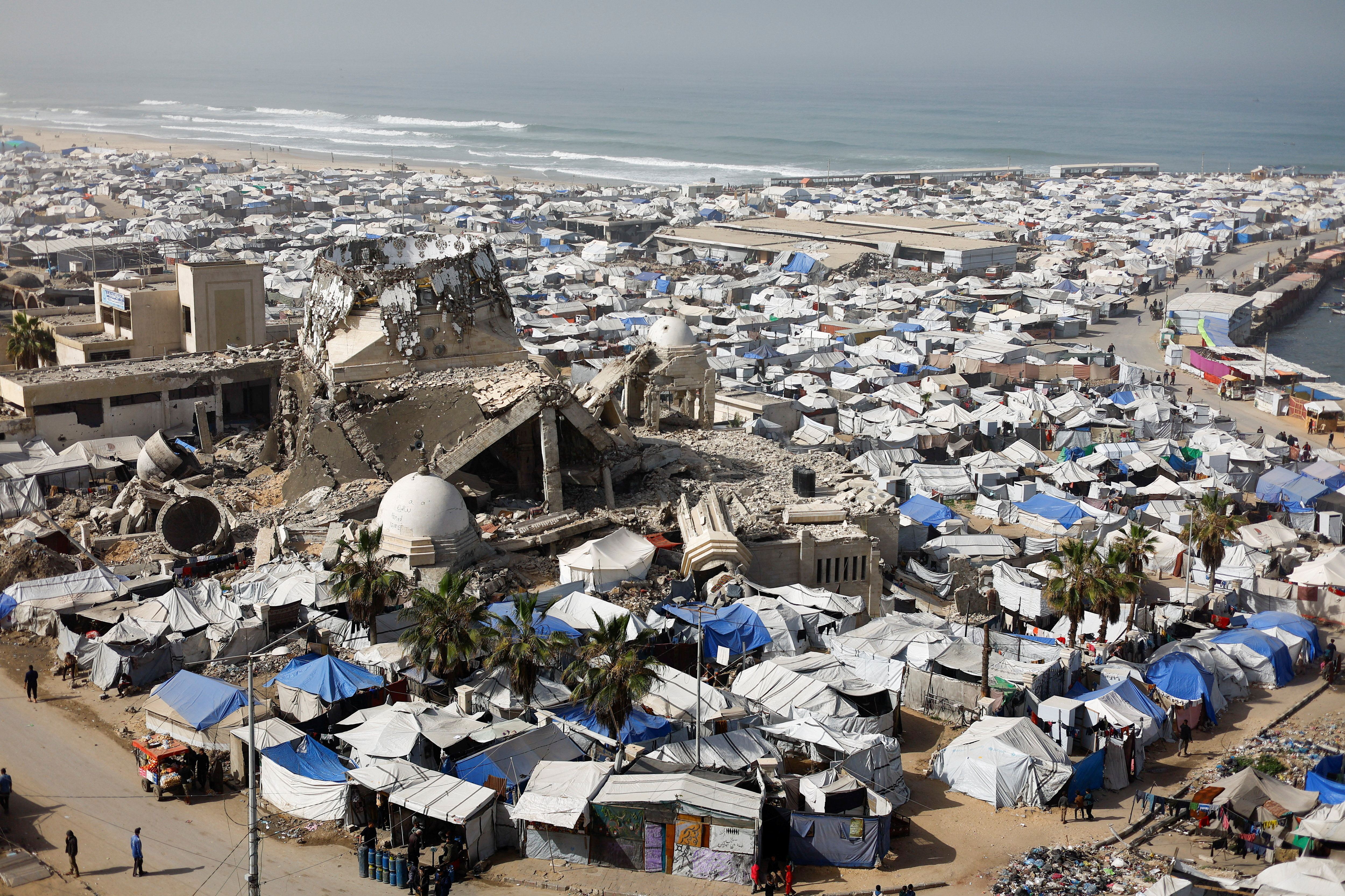A mosque, destroyed during the two-year Israeli offensives, is surrounded by tents for displaced Palestinians, in Gaza City, February 15, 2026. REUTERS/Mahmoud Issa