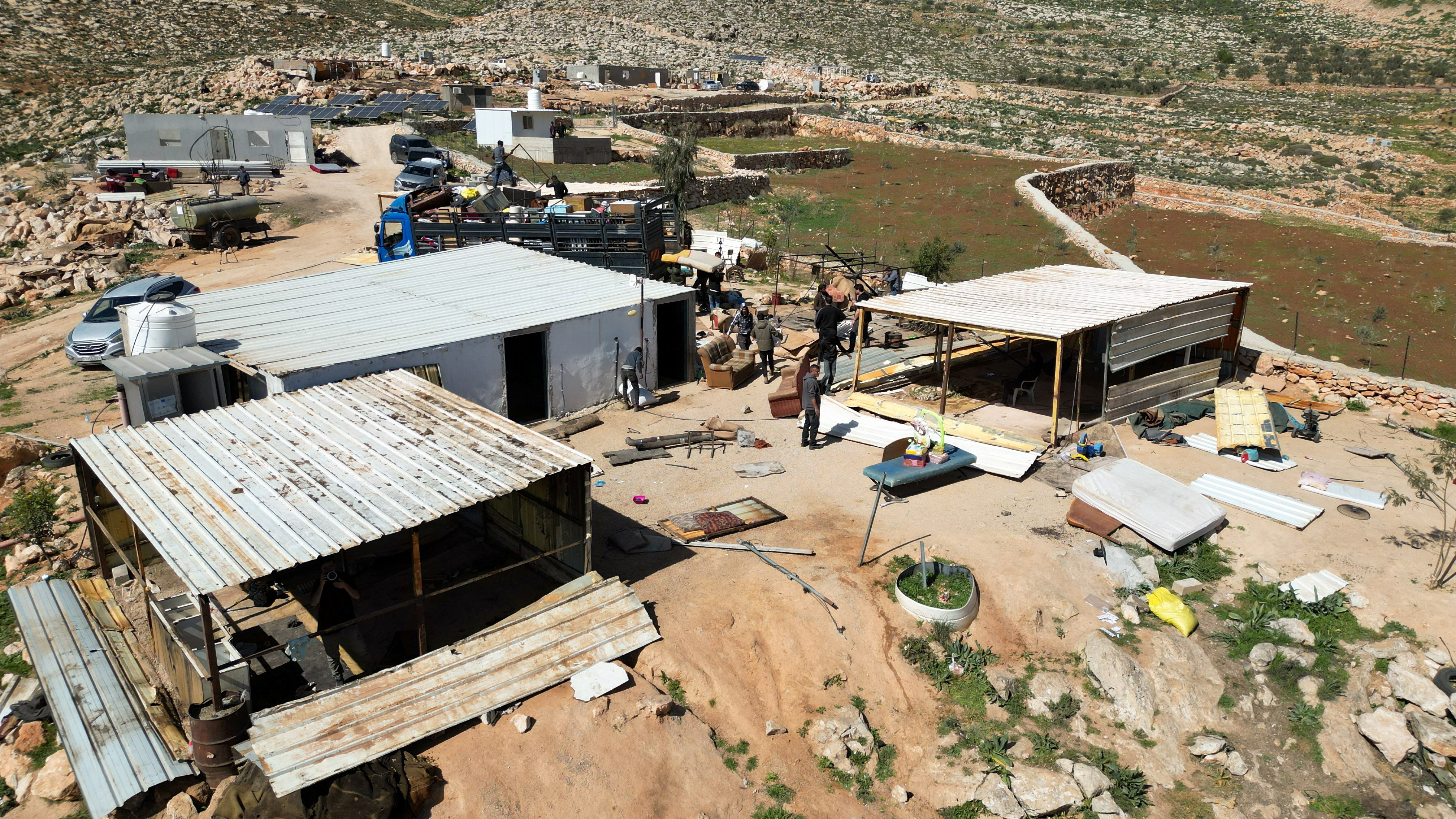 Members of a Palestinian Bedouin community prepare to leave following Israeli settler violence.