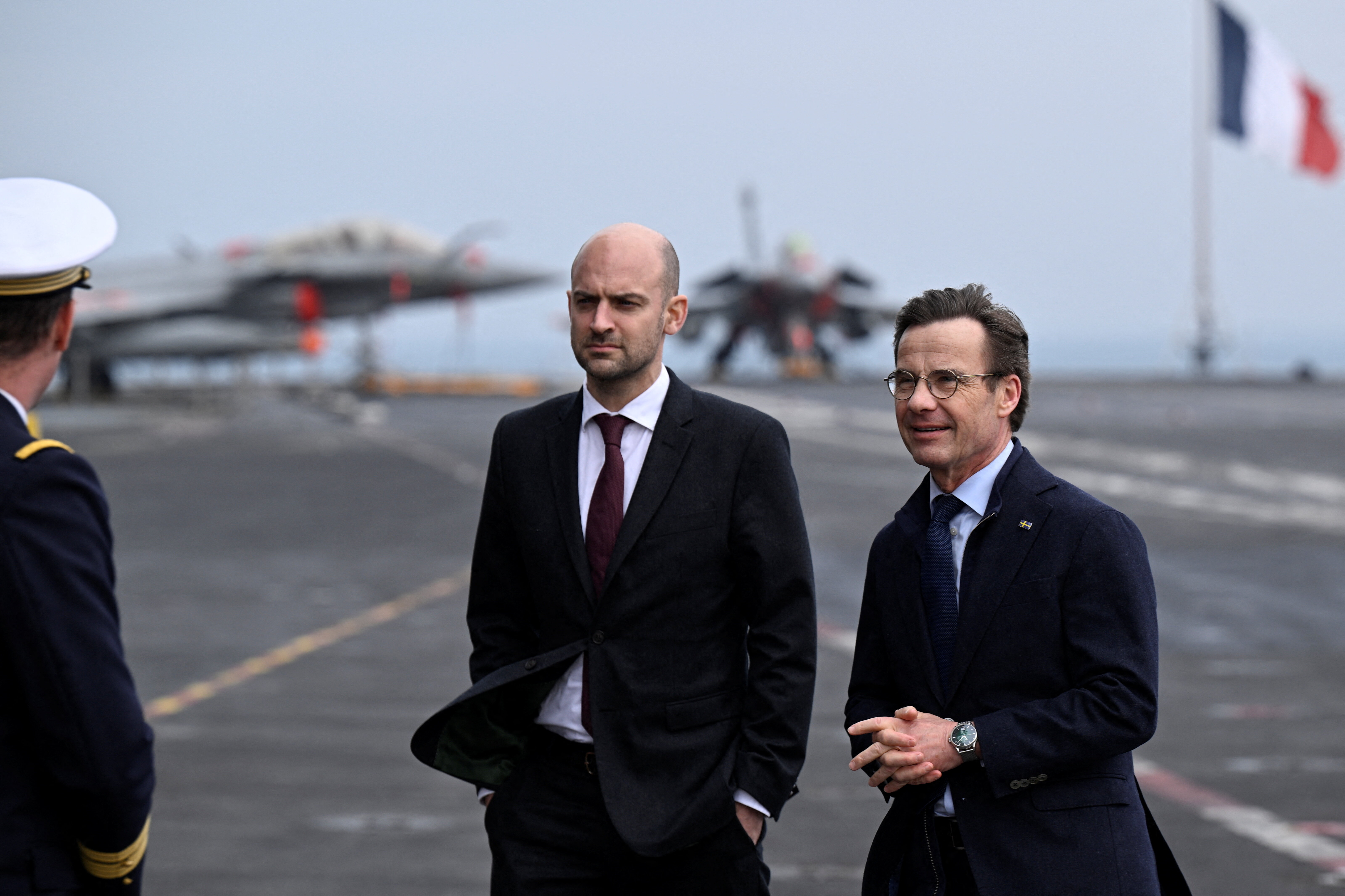 France's Minister for Europe and Foreign Affairs Jean-Noel Barrot and Sweden's Prime Minister Ulf Kristersson stand at the French aircraft carrier Charles De Gaulle (R91) on the day of the bilateral meeting, in Malmo, Sweden February 27, 2026. TT News Agency/Johan Nilsson/via REUTERS ATTENTION EDITORS - THIS IMAGE WAS PROVIDED BY A THIRD PARTY. SWEDEN OUT. NO COMMERCIAL OR EDITORIAL SALES IN SWEDEN.