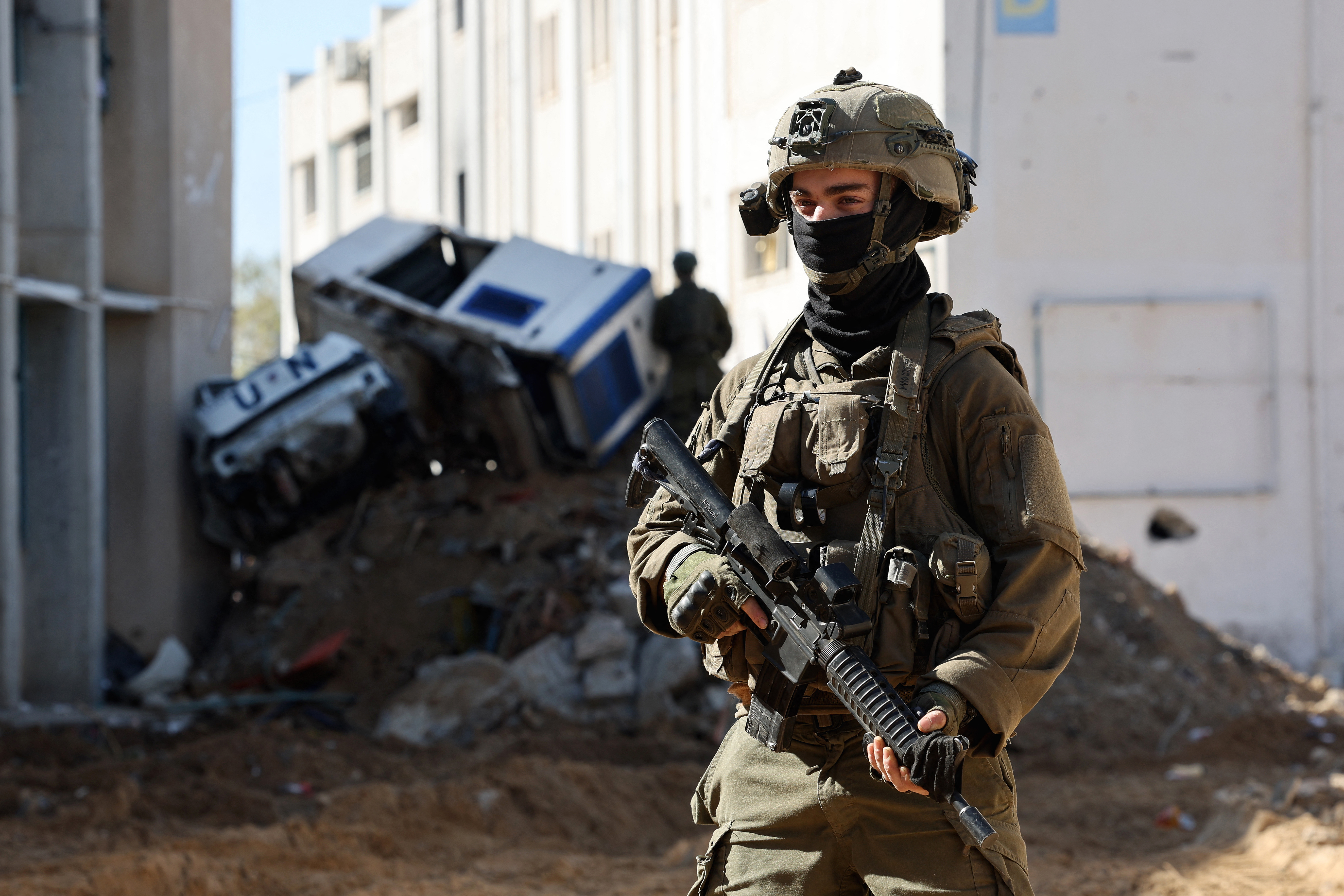 February 8, 2024, shows Israeli soldiers inside an evacuated compound of the United Nations Relief and Works Agency for Palestine Refugees (UNRWA) in Gaza City, amid ongoing fighting between Israel and the Palestinian militant group Hamas. (Photo by JACK GUEZ / AFP)