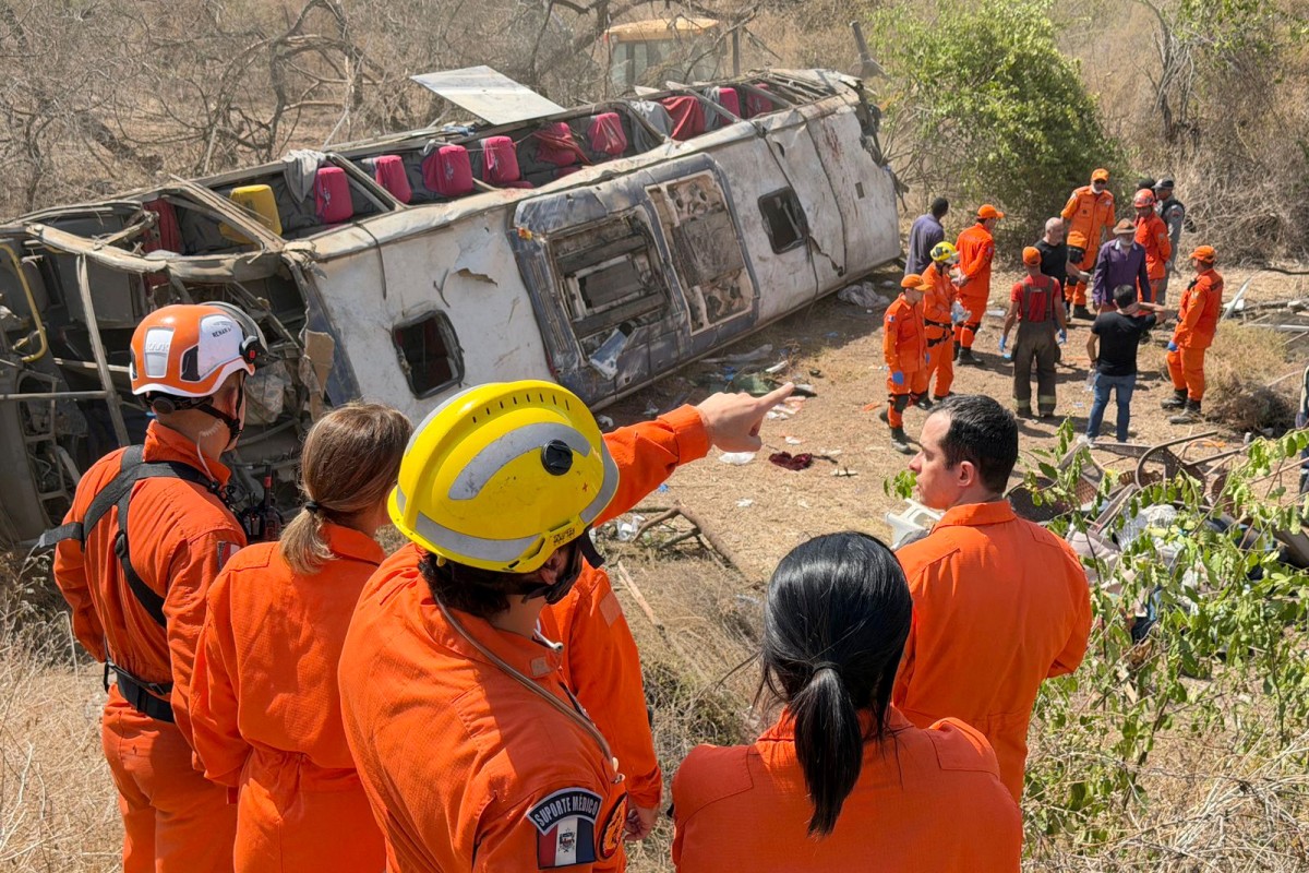 This handout photo provided by the Alagoas State government shows rescue officers working at the site of a deadly bus accident on state highway AL-220 in the city of Sao Jose da Tapera, Alagoas state, Brazil, on February 3, 2026.A bus accident in northeastern Brazil killed at least 15 people on February 3, including three children, state officials said in a statement. The bus had been carrying about 60 people taking part in a pilgrimage when it overturned in the rural interior of Alagoas state.