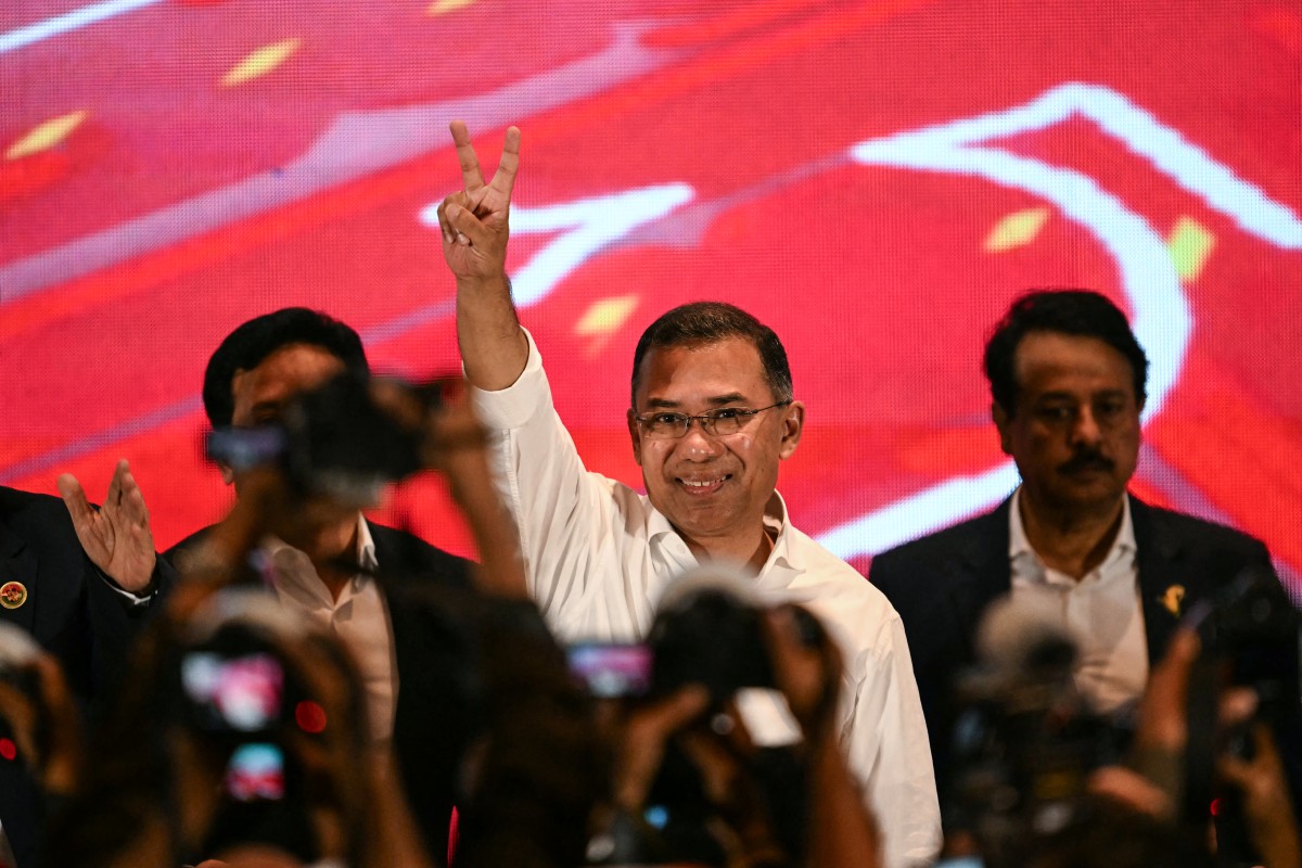 Bangladesh Nationalist Party (BNP) chairman Tarique Rahman (C) shows victory sign after addressing a press conference in Dhaka on February 14, 2026. Election Commission figures showed Rahman's BNP had won a landslide victory in the elections on February 12, the first since a deadly 2024 uprising ousted the iron-fisted rule of Sheikh Hasina.