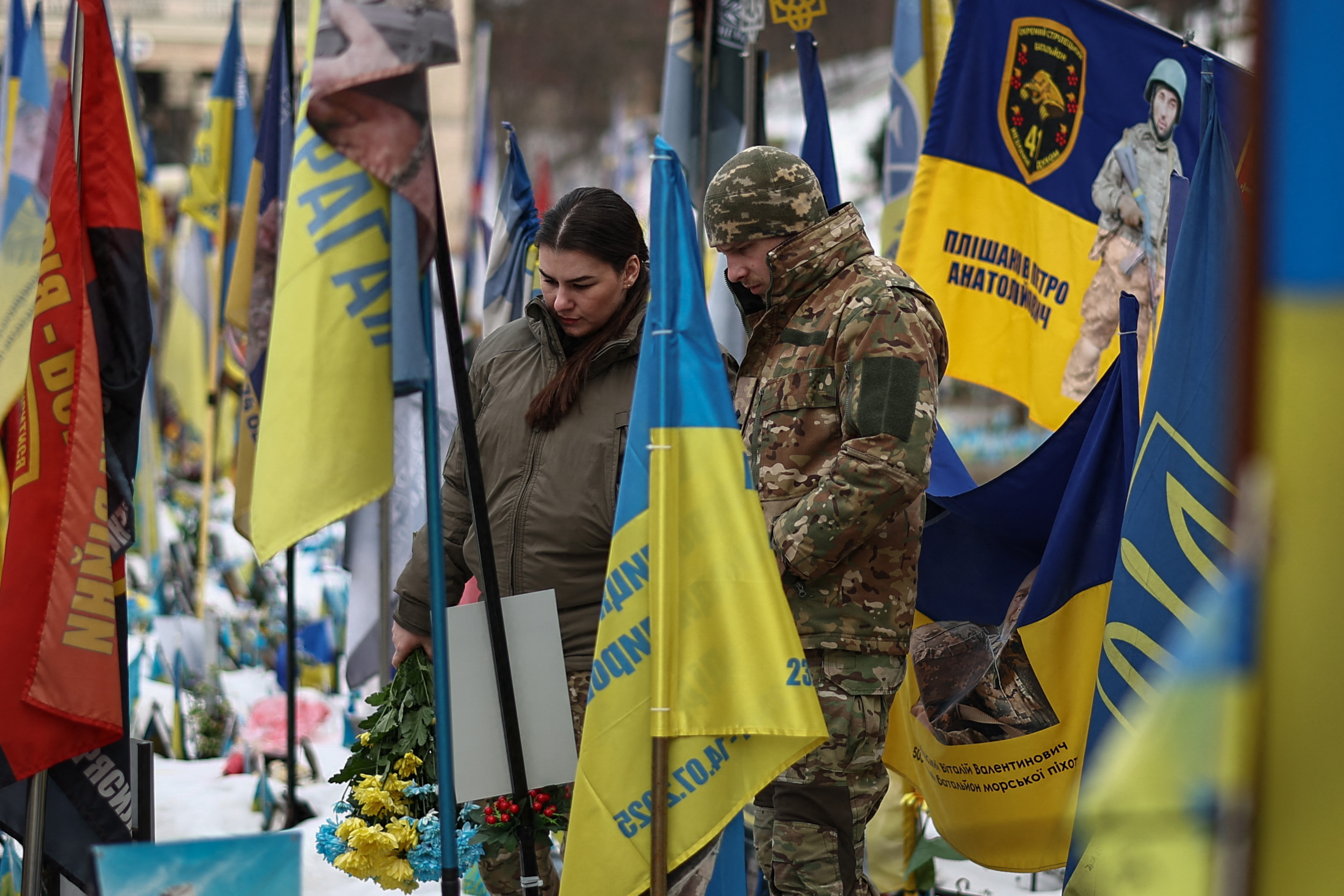 Local residents visit a makeshift memorial for Ukrainian and foreign soldiers in Independence Square in Kyiv on February 24, 2026, on the fourth anniversary of Russia’s invasion of Ukraine. [Henry Nichols/AFP]