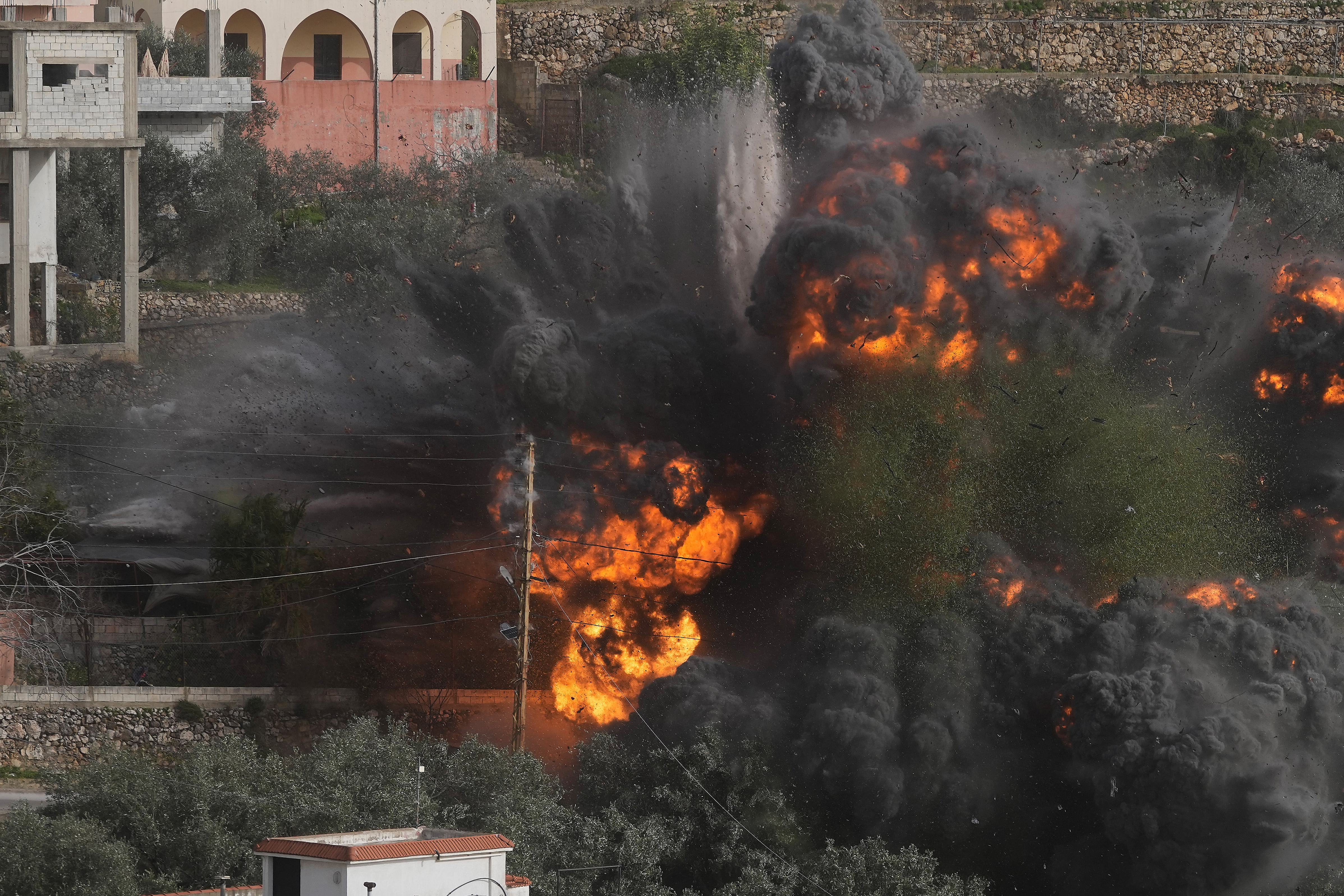 Flames and smoke rise from a building.