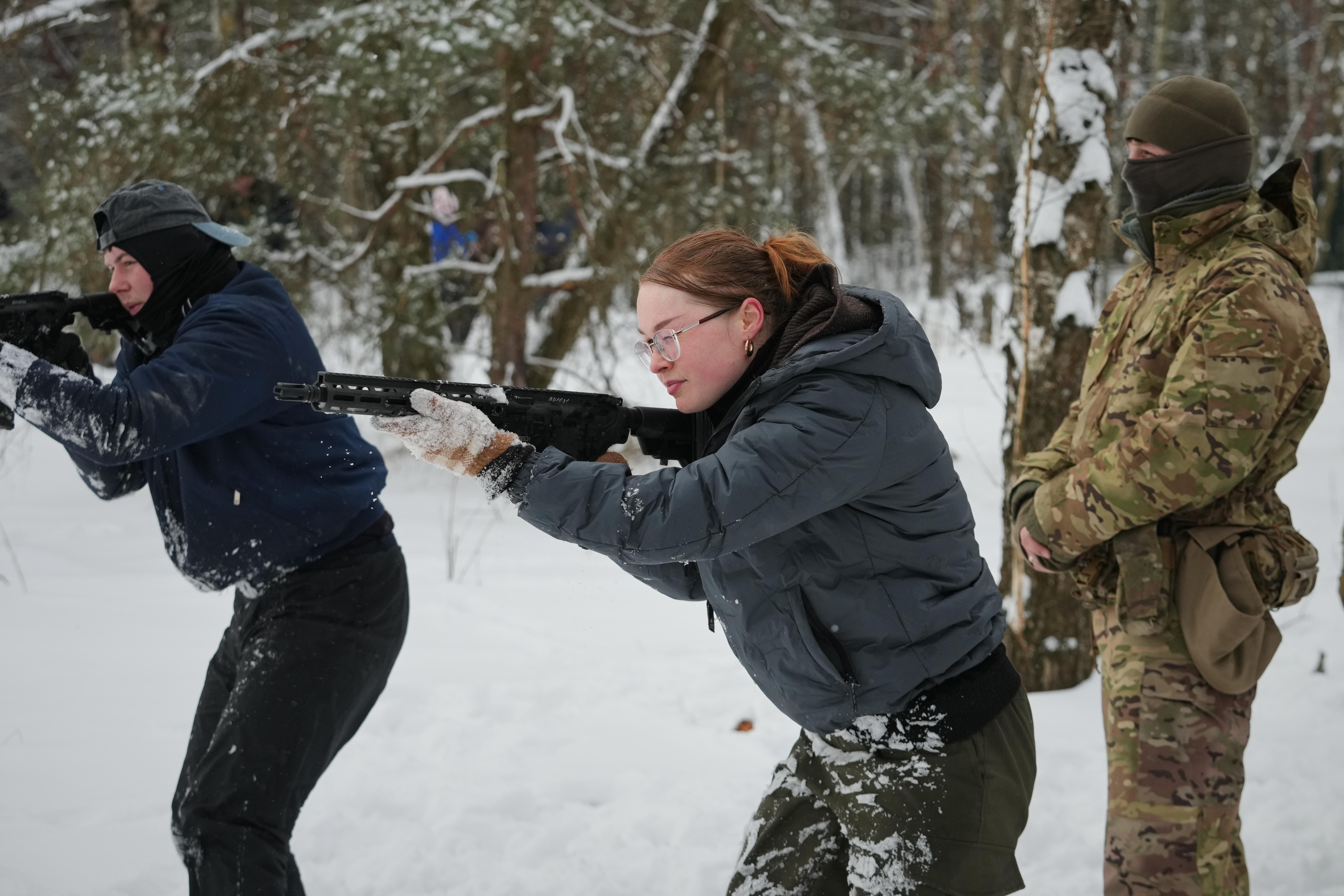 Participants of the a tactical and medical courses run by the 3rd Assault Brigade demonstrate their skills in a final exam for civilians in Kyiv regional center for preparing the population for national resistance, Ukraine, Sunday, Feb. 8, 2026. (AP Photo/Sergei Grits)