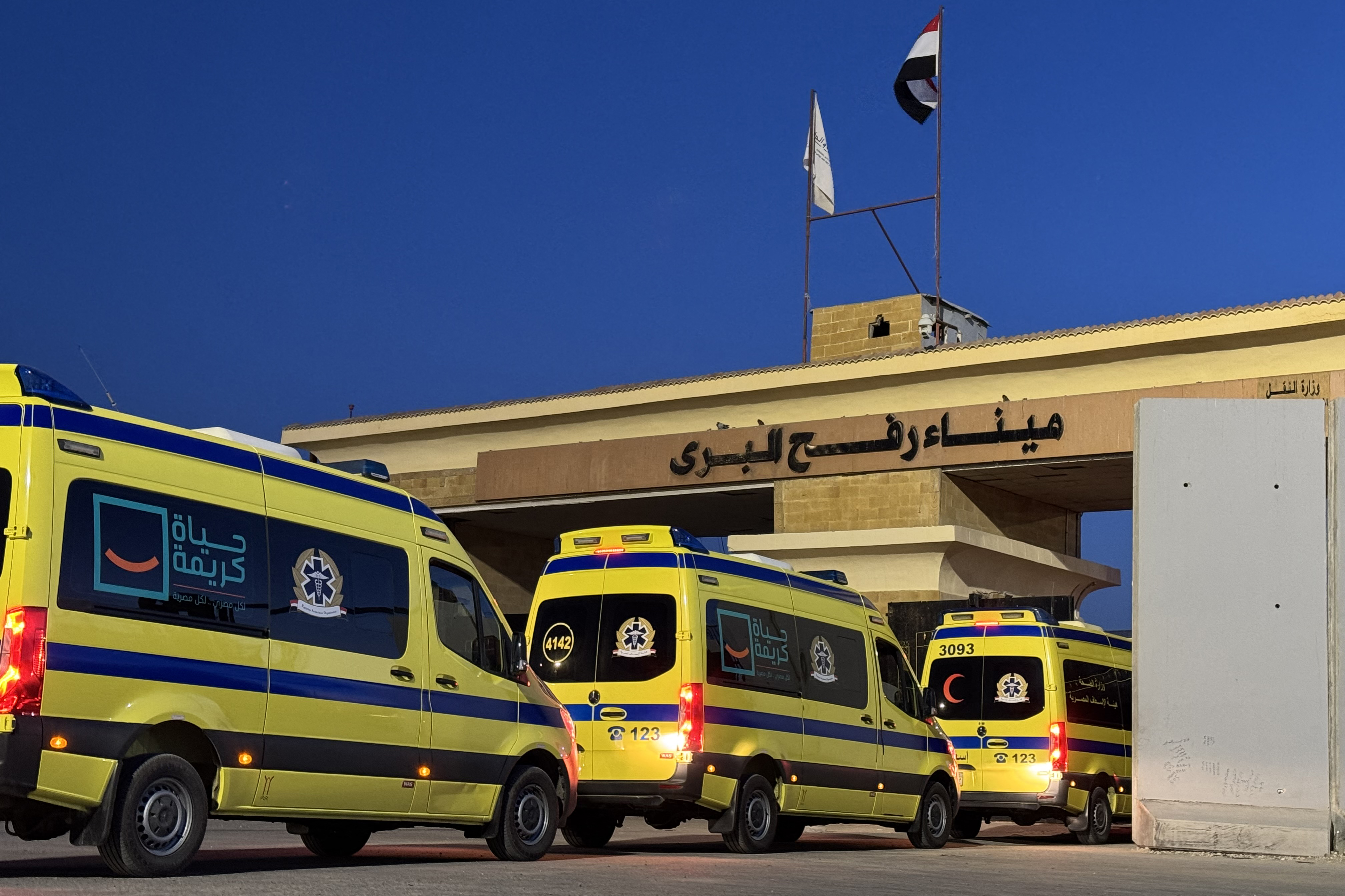 TOPSHOT - Ambulances wait in line at the Egyptian side of the Rafah border crossing with the Palestinian Gaza Strip, in northeastern Egypt on the first day of the evacuation of some 50 Palestinian, at the Rafah crossing on February 2, 2026.