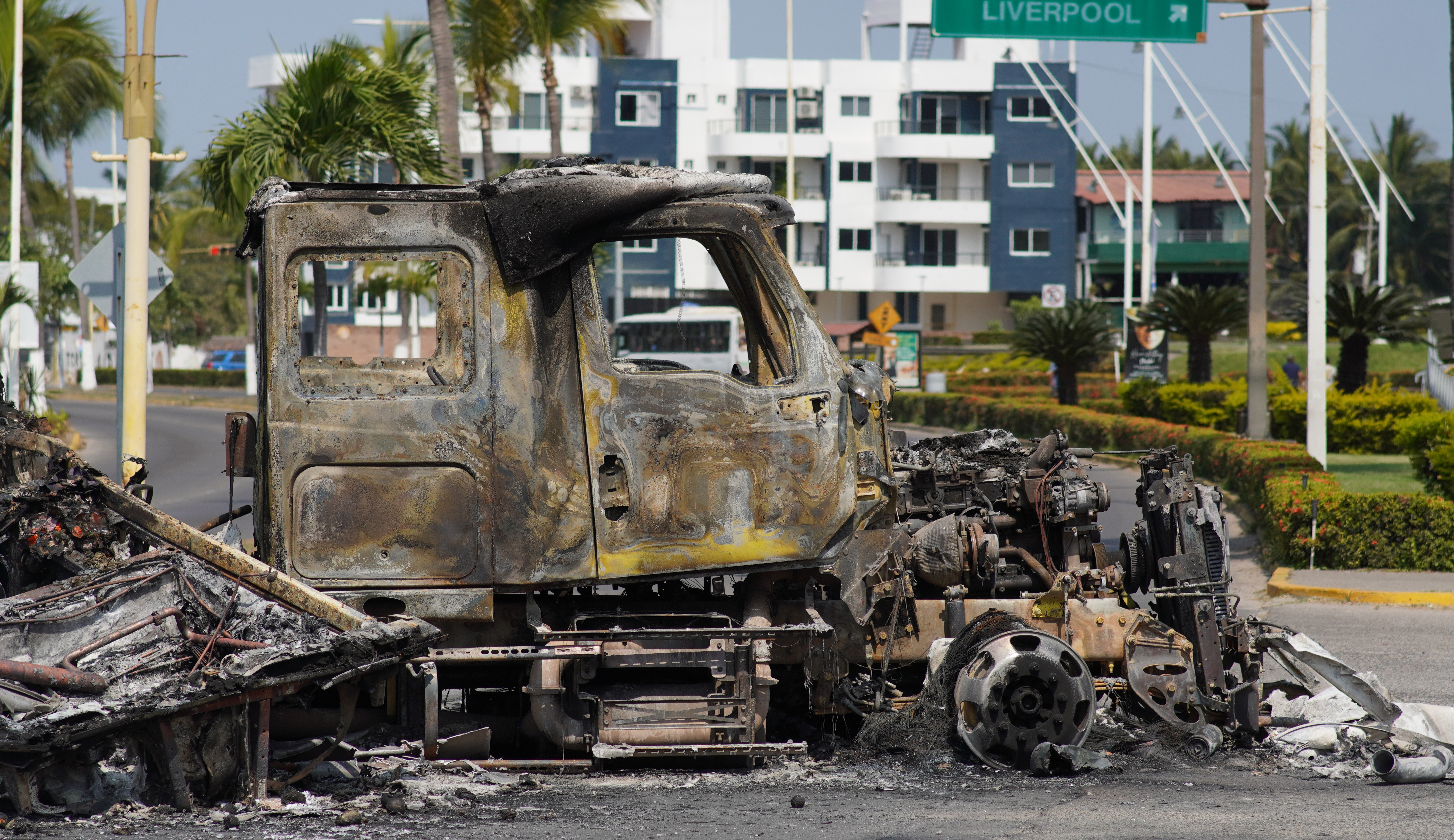 epa12772352 Burned out vehicles are seen on the boardwalk in Puerto Vallarta, Mexico, 23 February 2026. The resort city reports visible disruptions after violence linked to the killing of drug cartel leader Nemesio Oseguera Cervantes, known as El Mencho, in a military operation. EPA/Arturo Montero