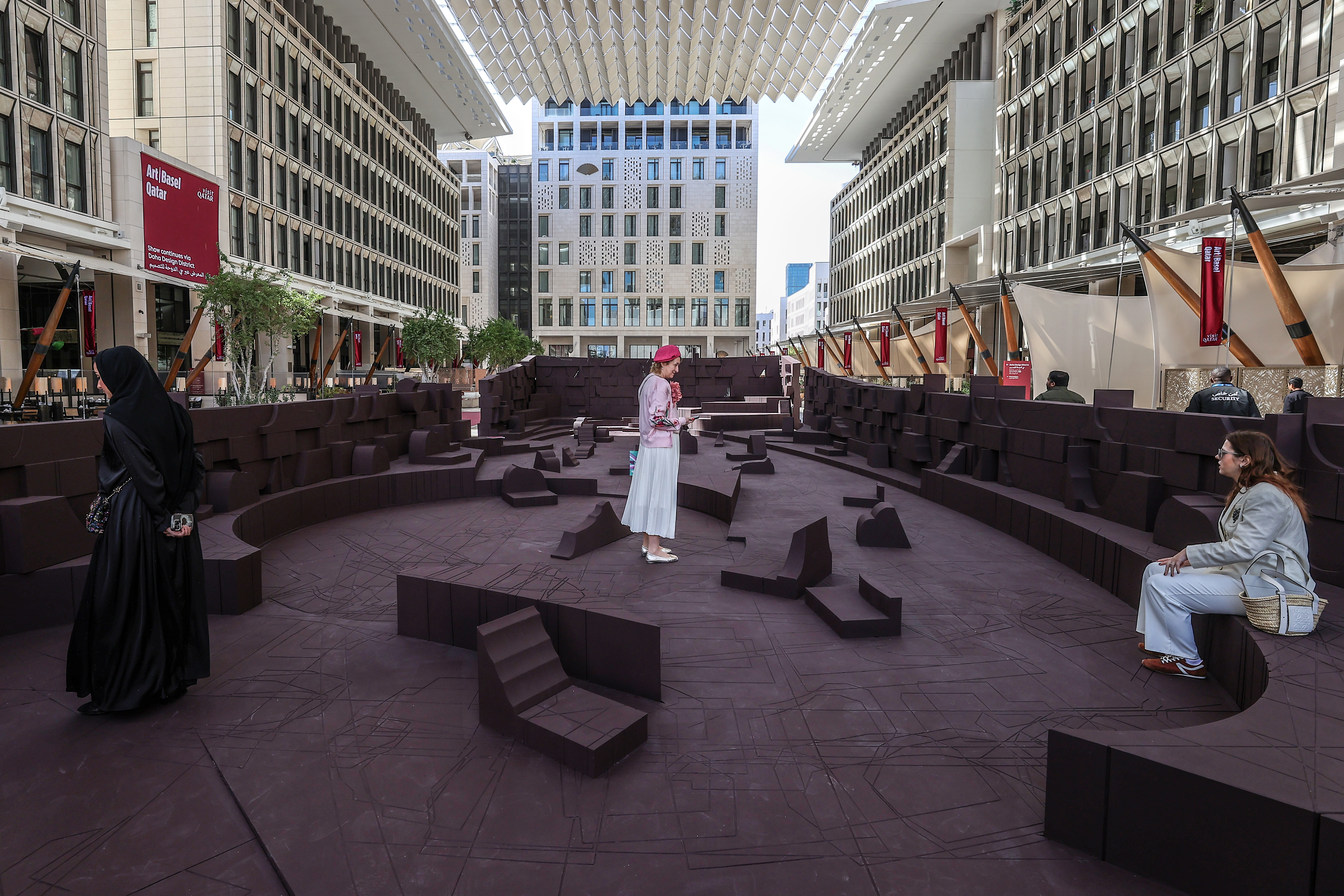 Visitors explore artworks and installations at the Art Basel Qatar Edition in Doha