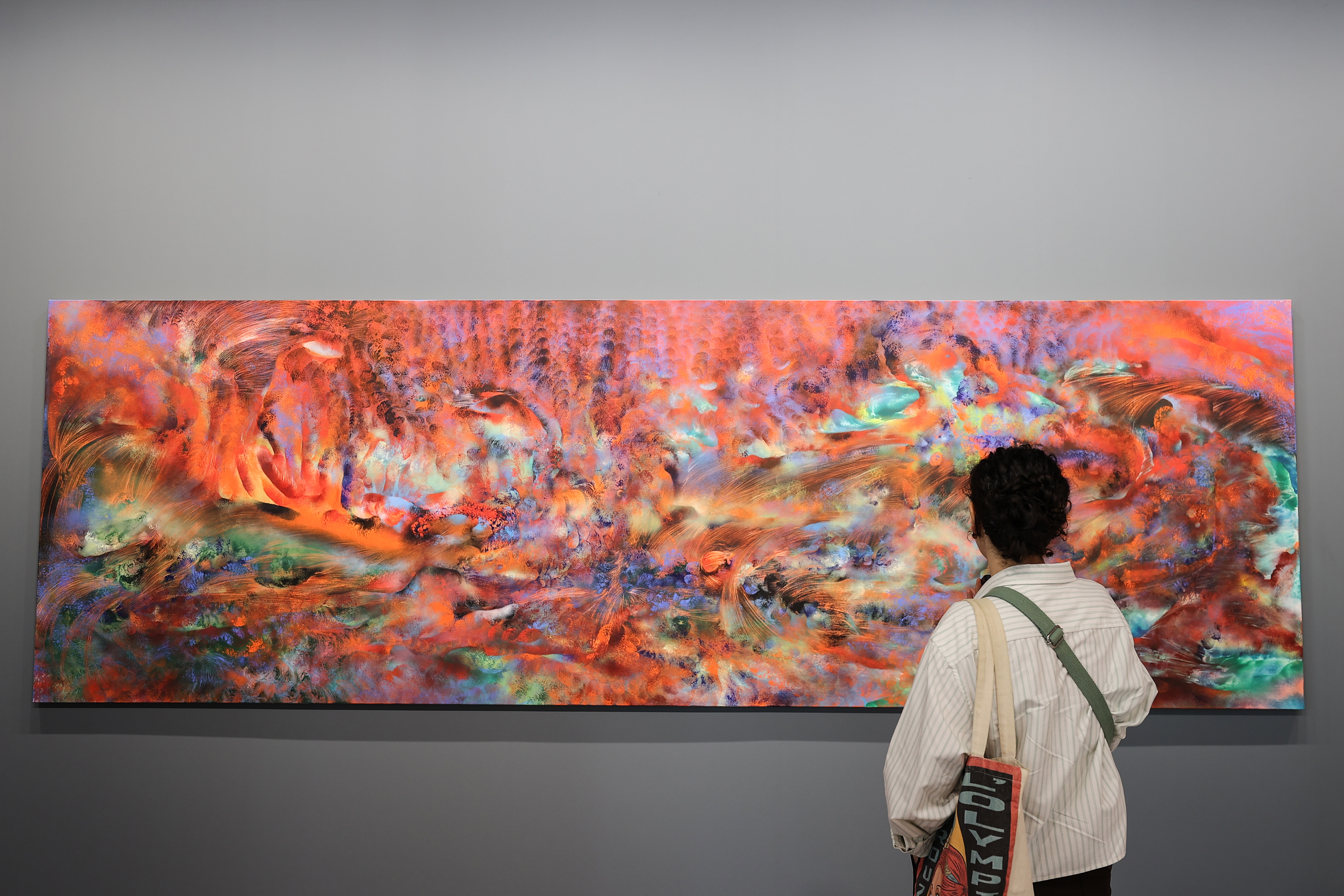 Visitors explore artworks and installations at the Art Basel Qatar Edition in Doha