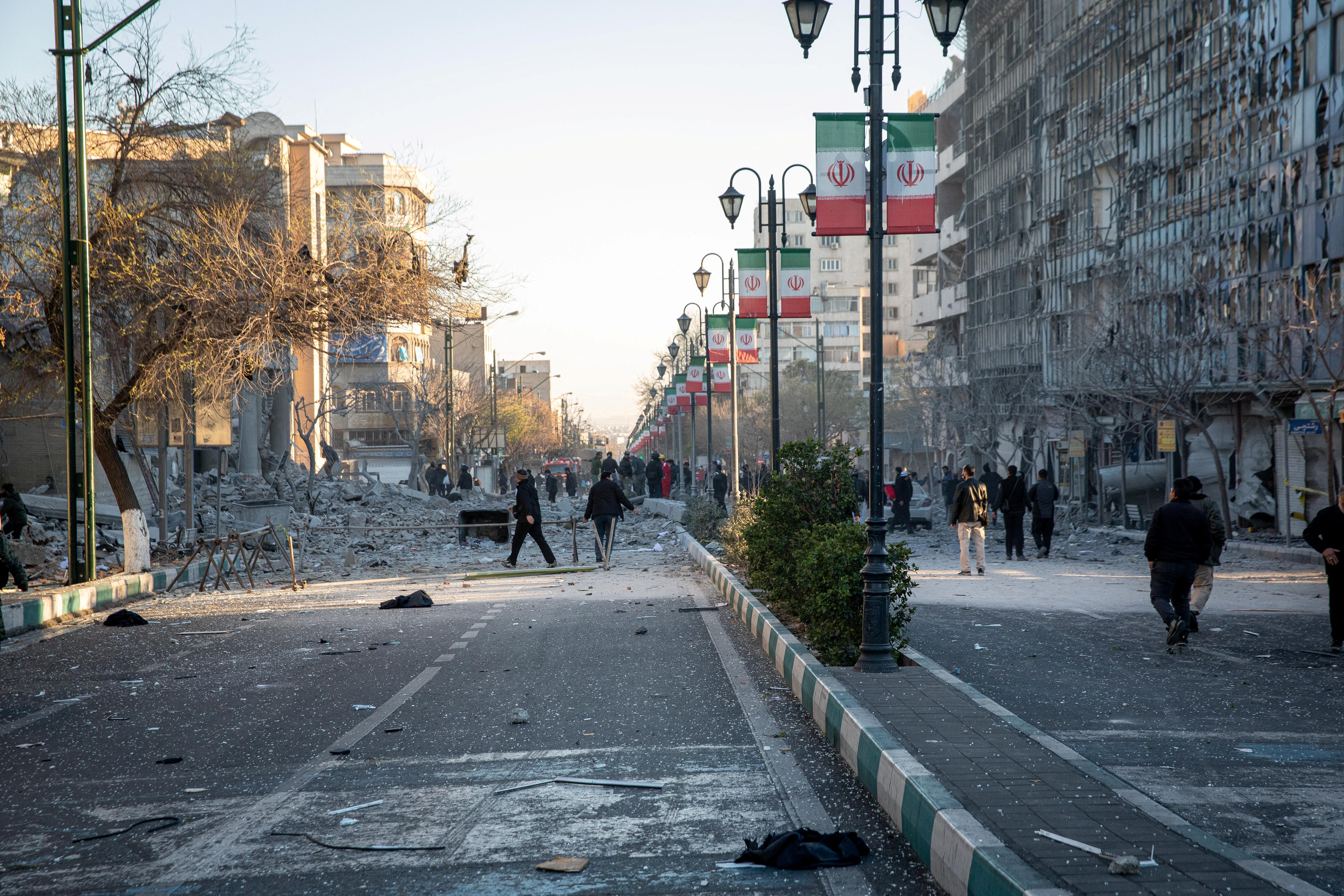 People gather at the site of a US-Israel strike on a police station in Tehran.