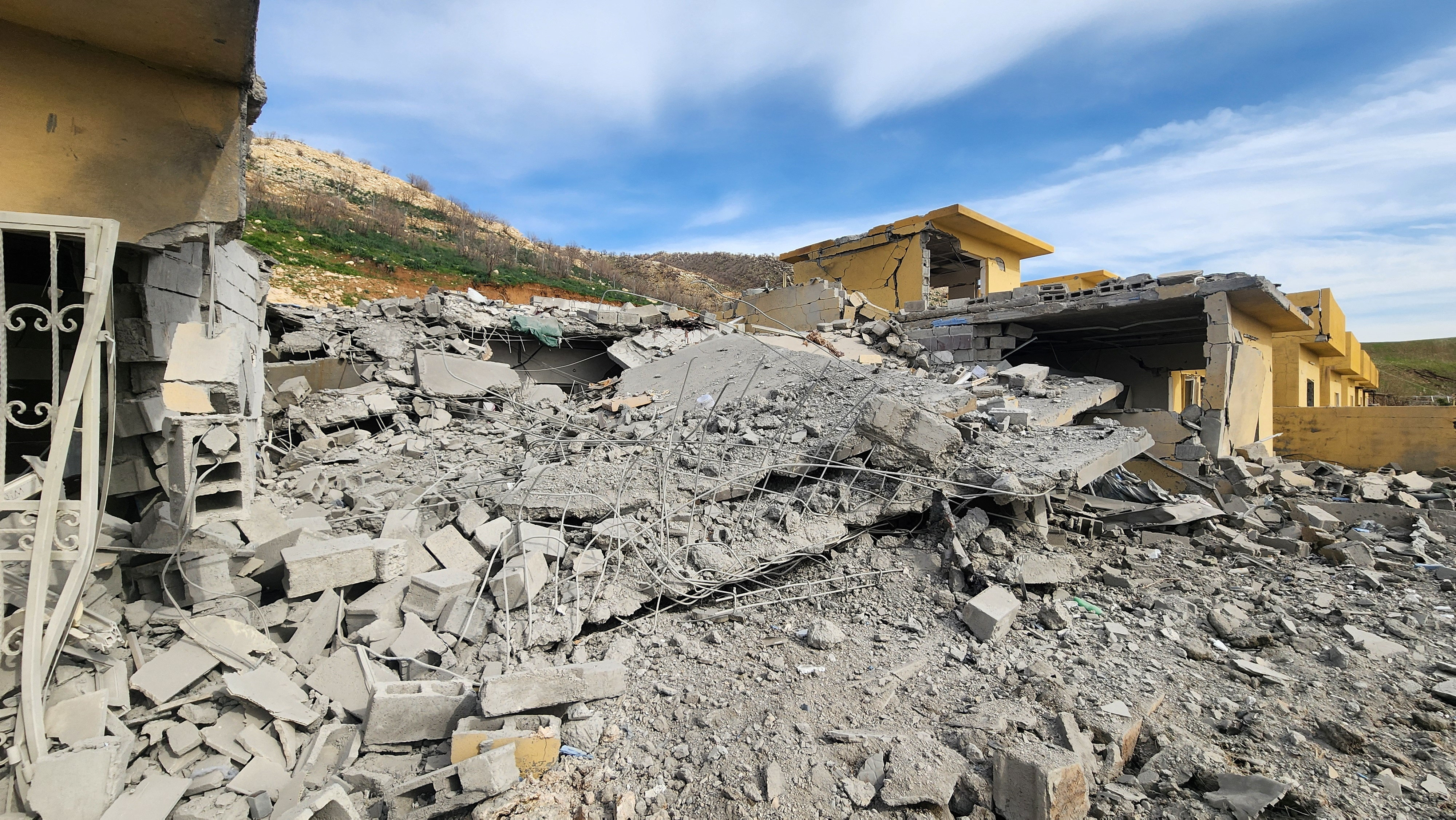 Rubble of destroyed buildings lies following, what the security sources say, a drone struck an arms depot in an attack on the headquarters of an Iranian Kurdish opposition group in which two fighters were wounded, amid the U.S.-Israeli conflict with Iran, in the town of Dekala in Iraq's Kurdistan region