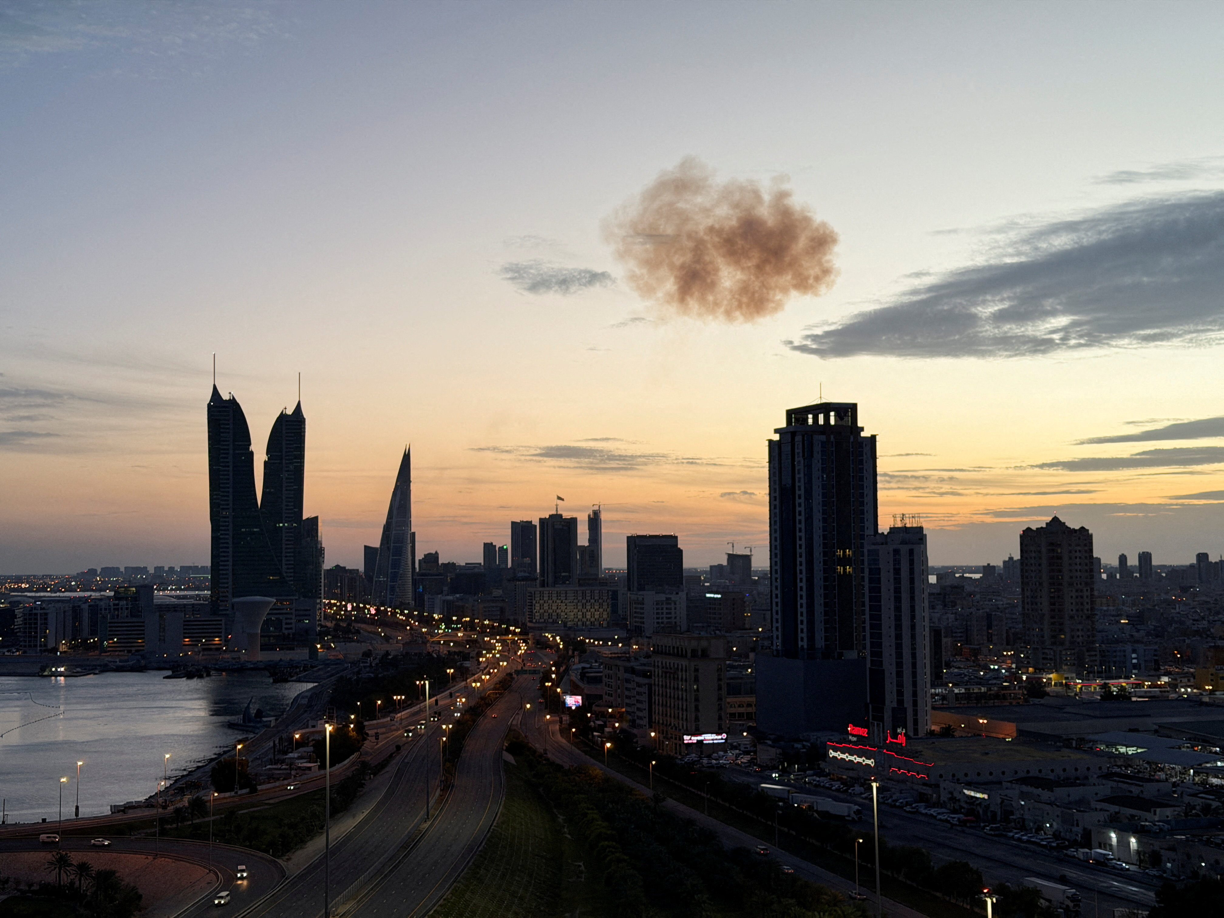Smoke rises after an Iranian drone was intercepted over the Bahrain Financial Harbour Towers.