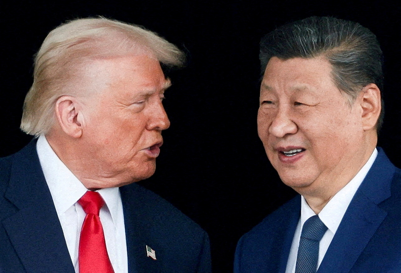 FILE PHOTO: U.S. President Donald Trump and Chinese President Xi Jinping talk as they leave after a bilateral meeting at Gimhae International Airport, on the sidelines of the Asia-Pacific Economic Cooperation (APEC) summit, in Busan, South Korea, October 30, 2025. REUTERS/Evelyn Hockstein/File Photo