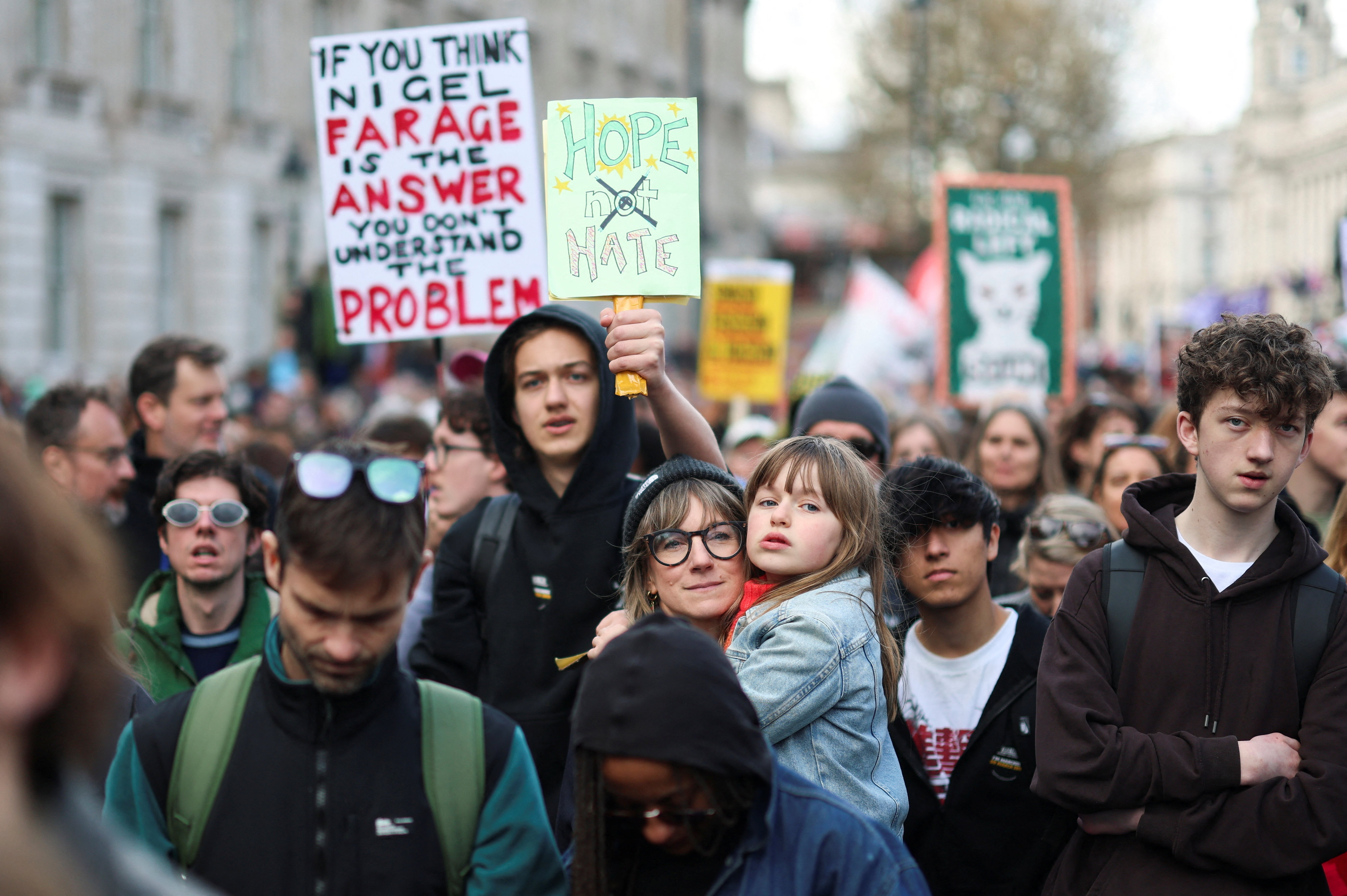 A man holds a placard, as demonstrators march against far-right extremism from Park Lane to Trafalgar Square, organised by the Together Alliance, a coalition of unions and civil society groups, in London, Britain, March 28, 2026. REUTERS/Hannah McKay