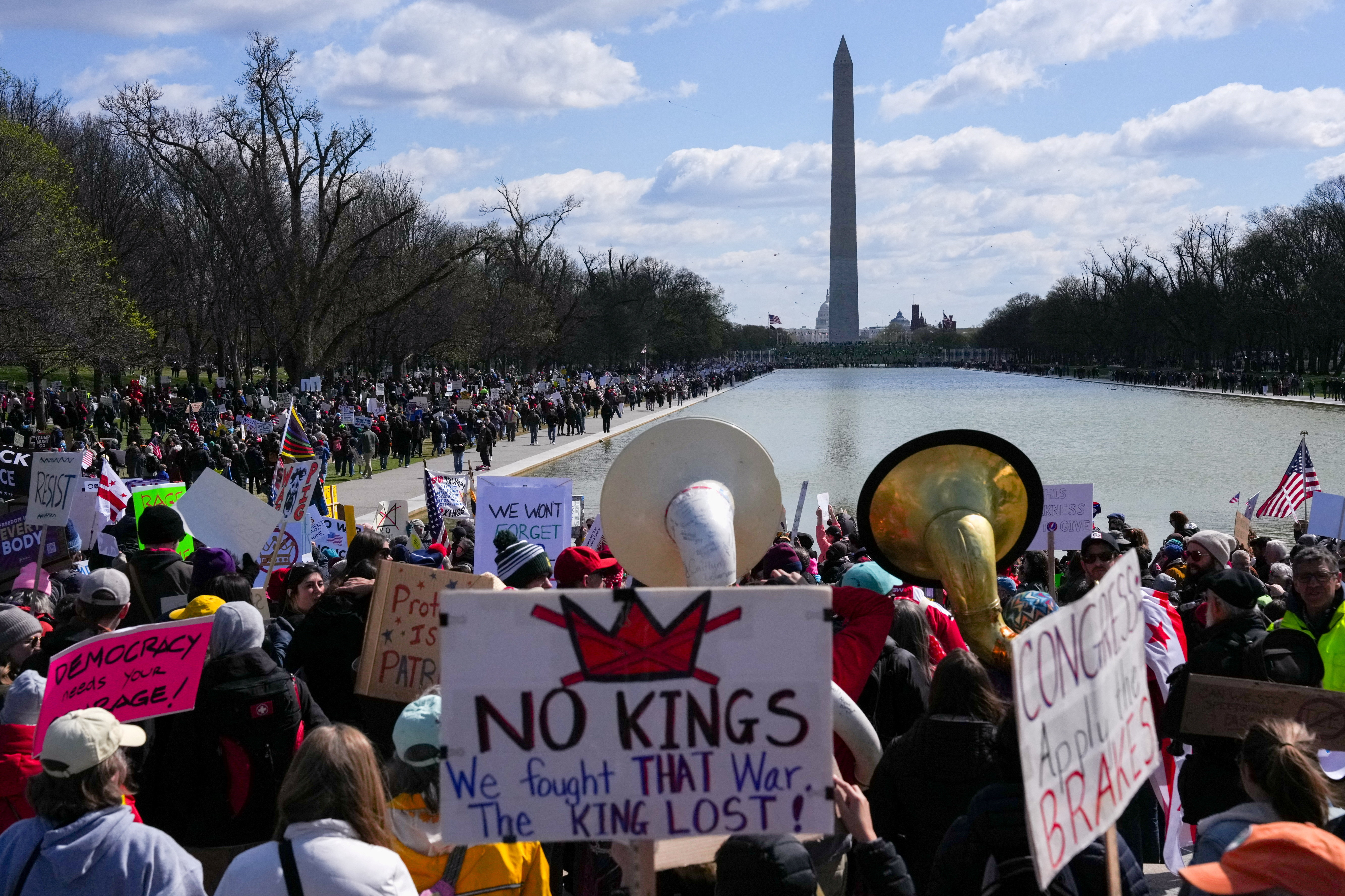 Demonstrators in Washington DC with the Washington Monument in the background
