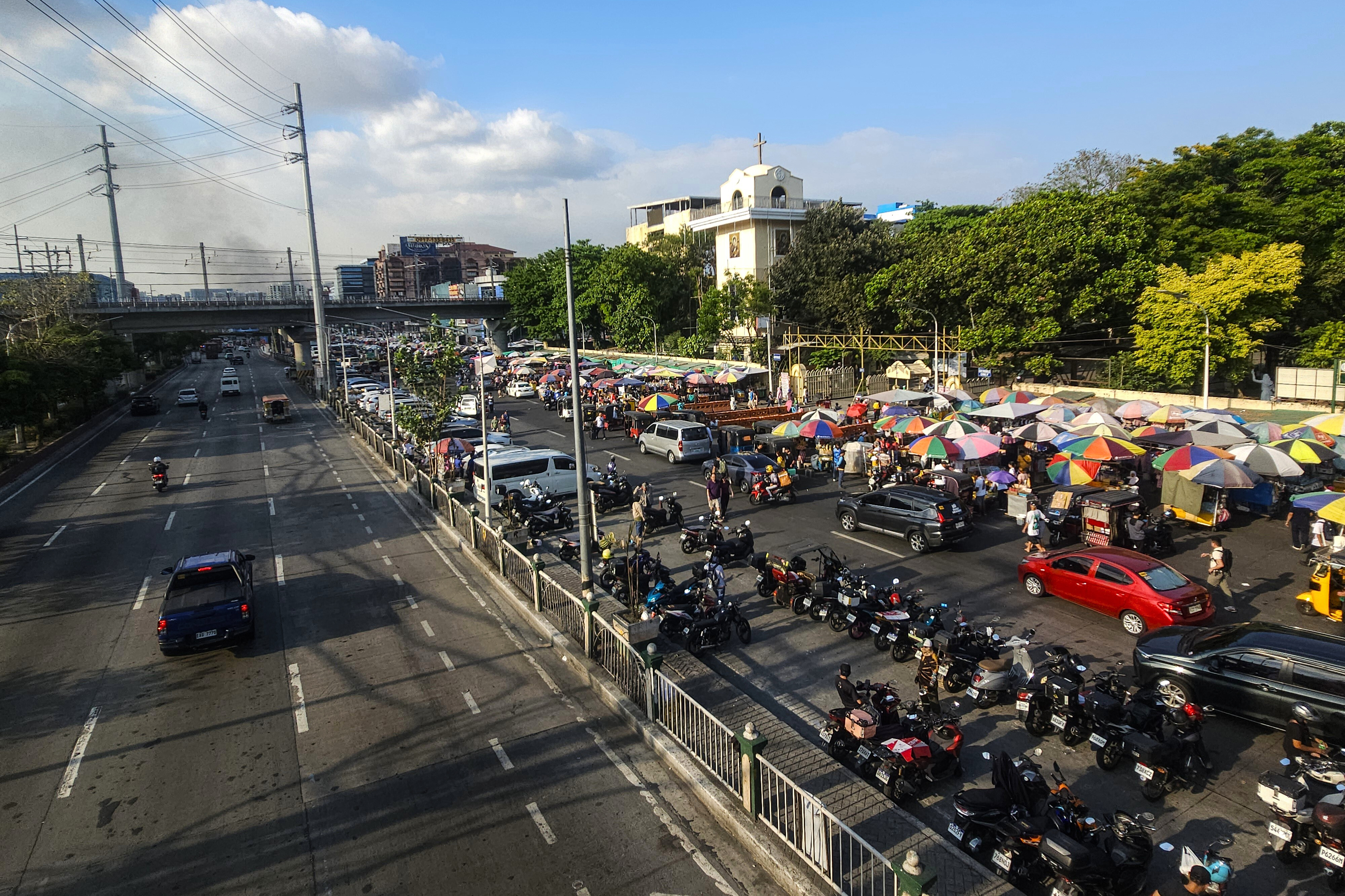 Outside Baclaran Church, the usual festive chaos during Wednesdays when thousands flock to the Catholic shrine, have been replaced with a more sombre display of devotion.