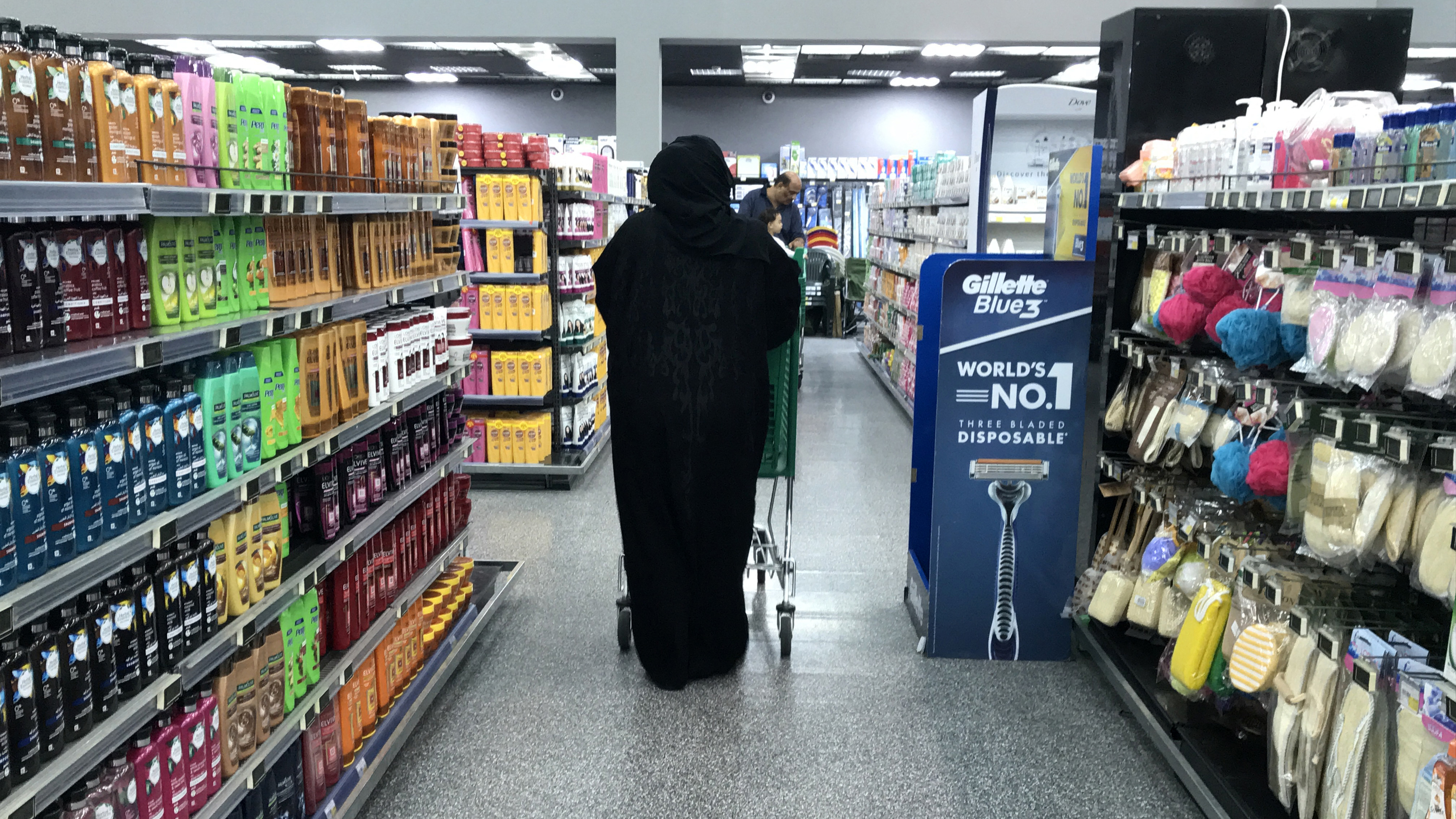 A picture taken on May 27, 2018 shows a woman browsing for goods in a supermarket in the Qatari capital Doha. (Photo by AFP)