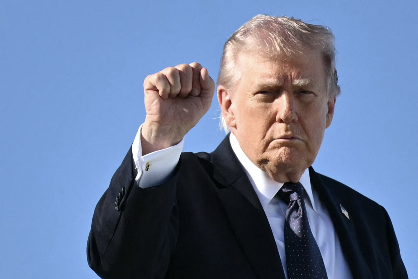 US President Donald Trump gestures as he boards Air Force One