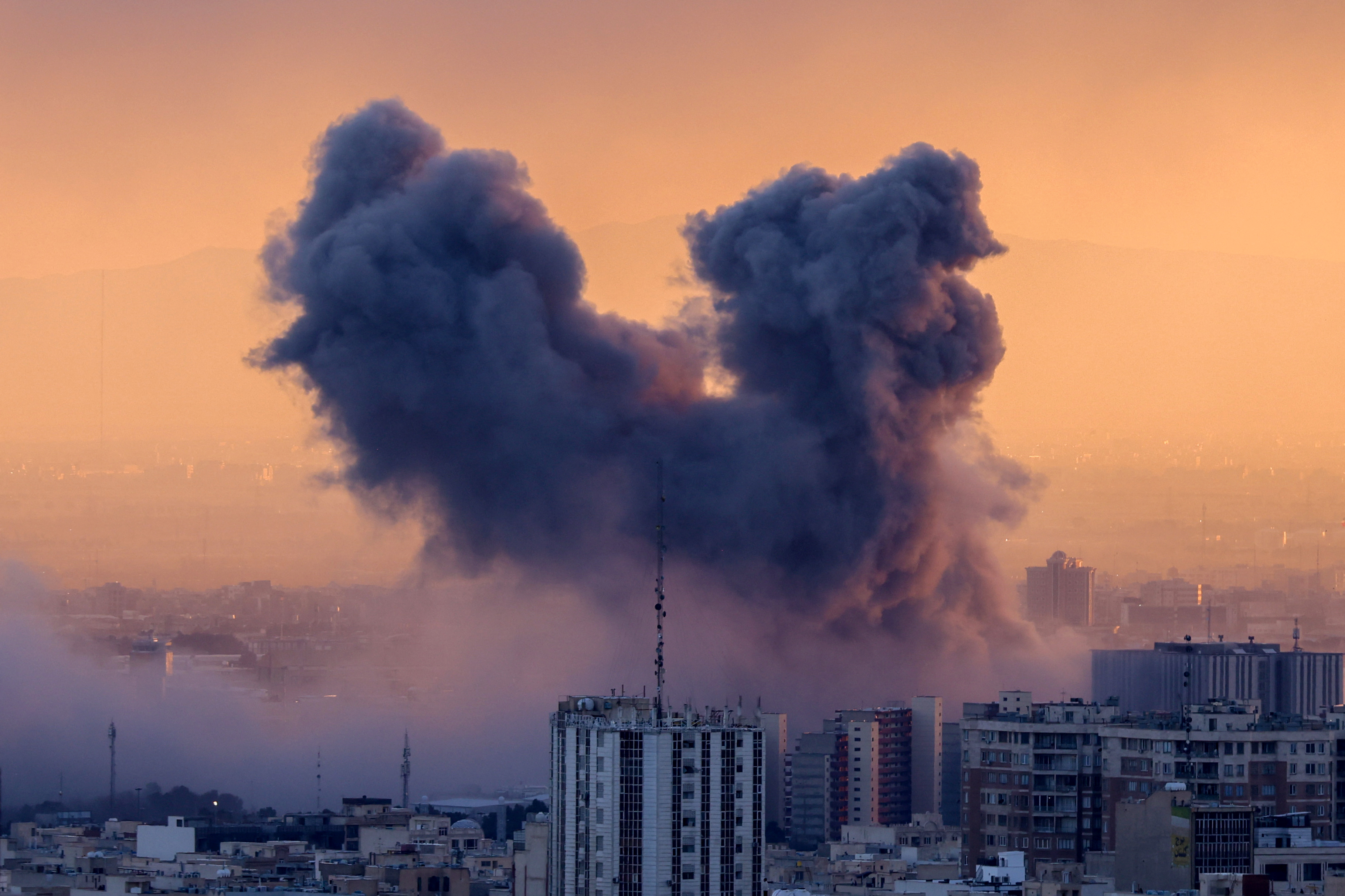 A plume of smoke rises after an attack on the Iranian capital Tehran.