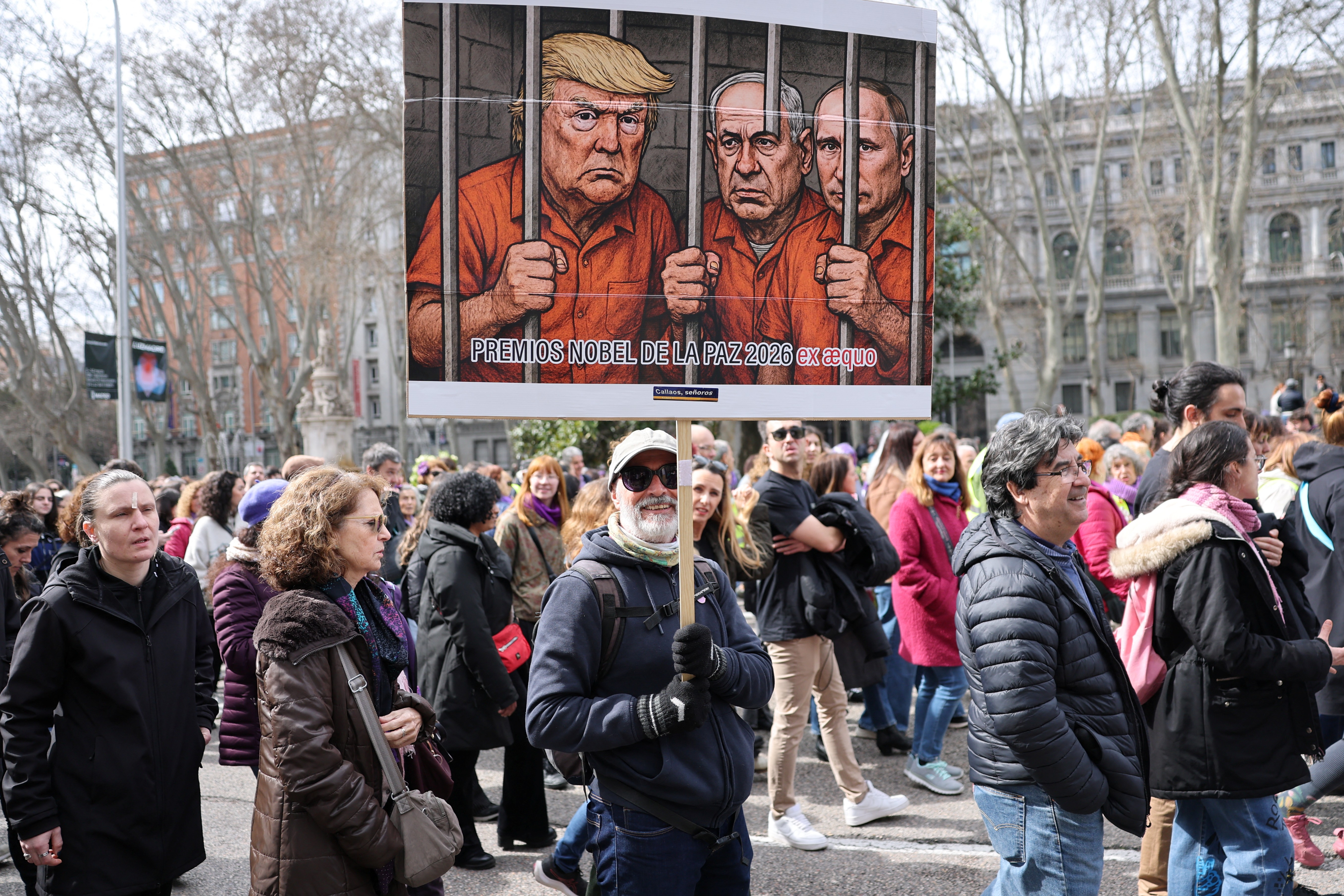 A banner mocks US President Donald Trump, Israeli Prime Minister Benjamin Netanyahu and Russian President Vladimir Putin at an International Women’s Day rally in Madrid, Spain on March 8, 2026