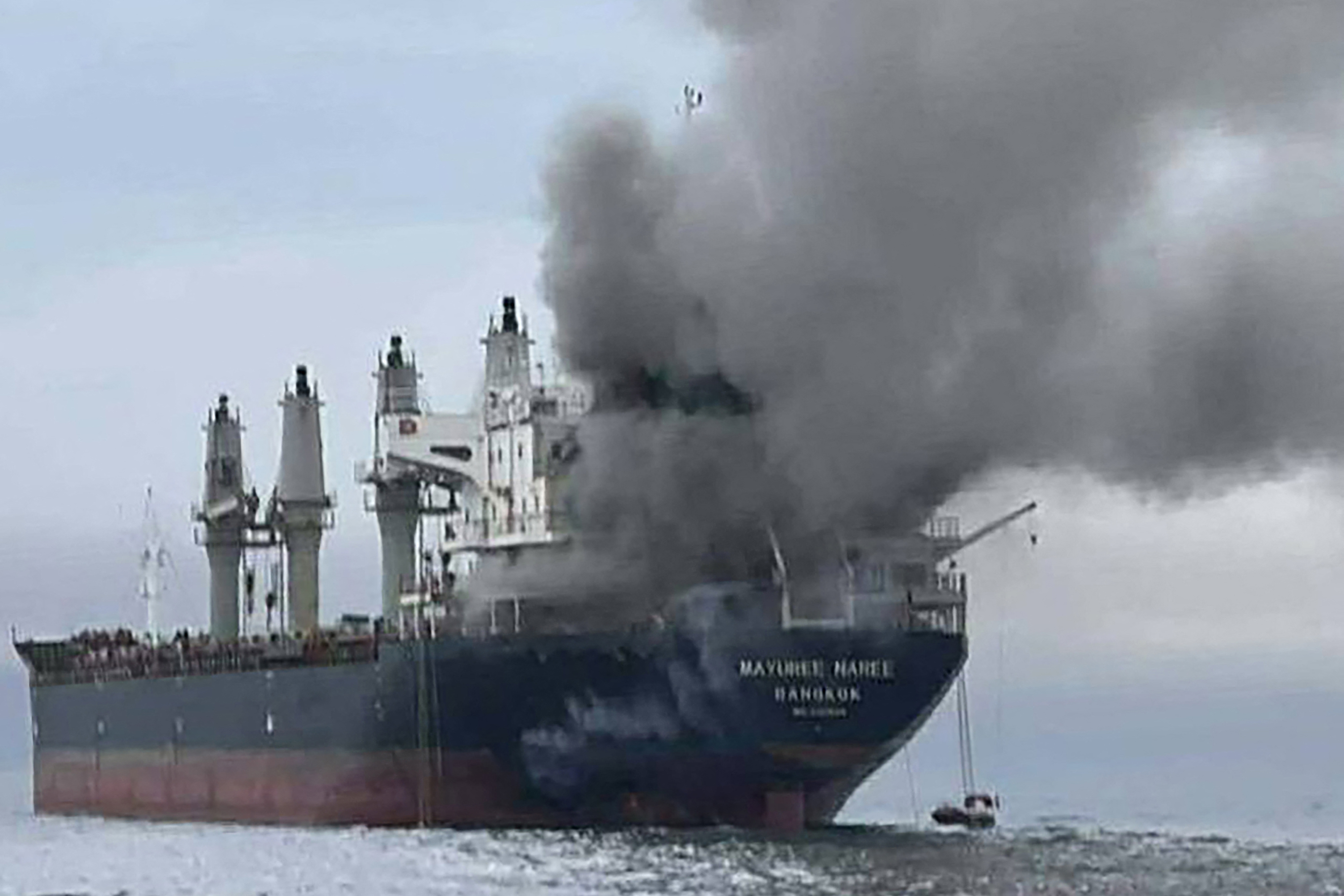 Smoke rising from a ship after an attack.