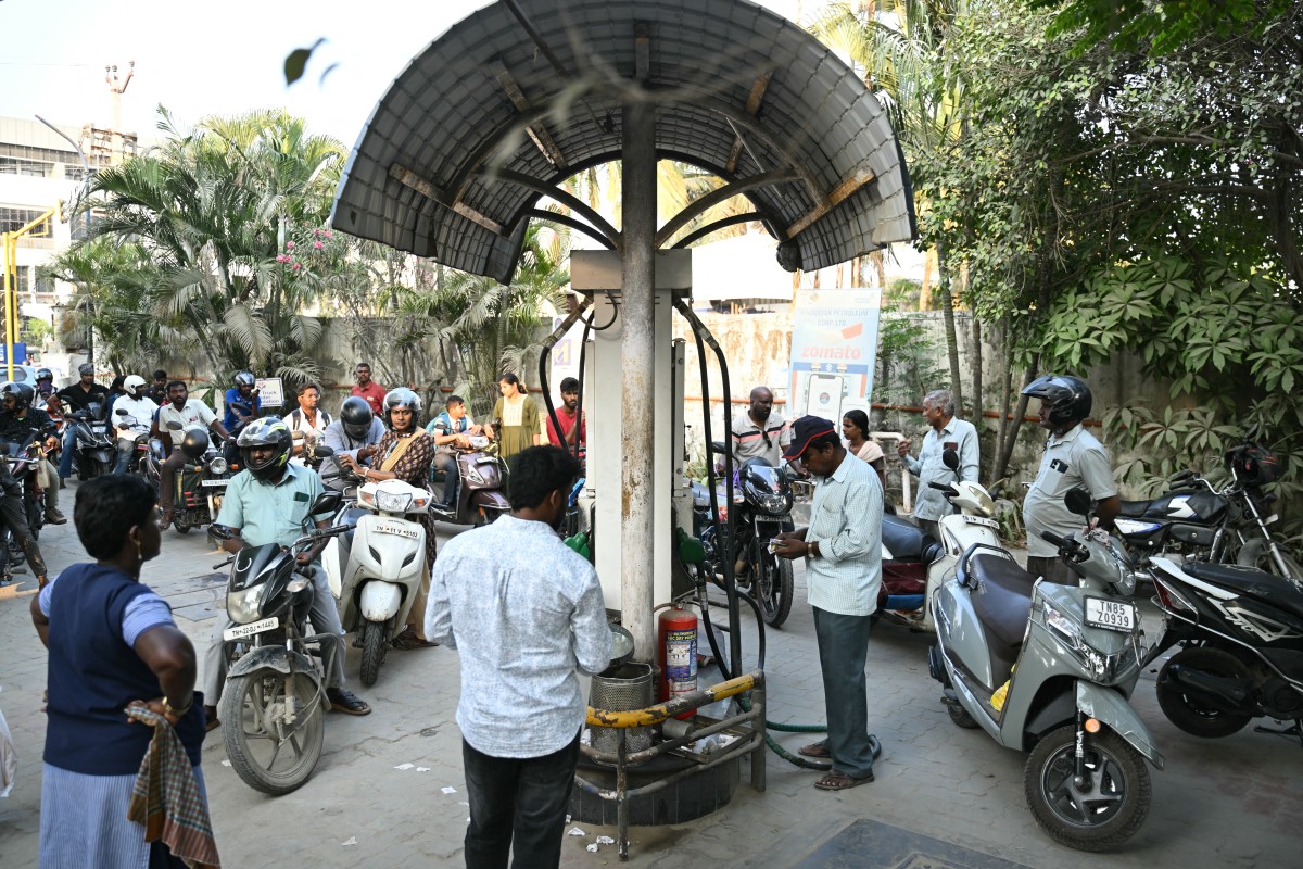 People queue to refuel their vehicles at a petrol station in Chennai on March 12, 2026 as an oil price spike caused by the war in the Middle East causes exasperation at petrol pumps across Asia, where many economies are heavily dependent on fossil fuel imports
