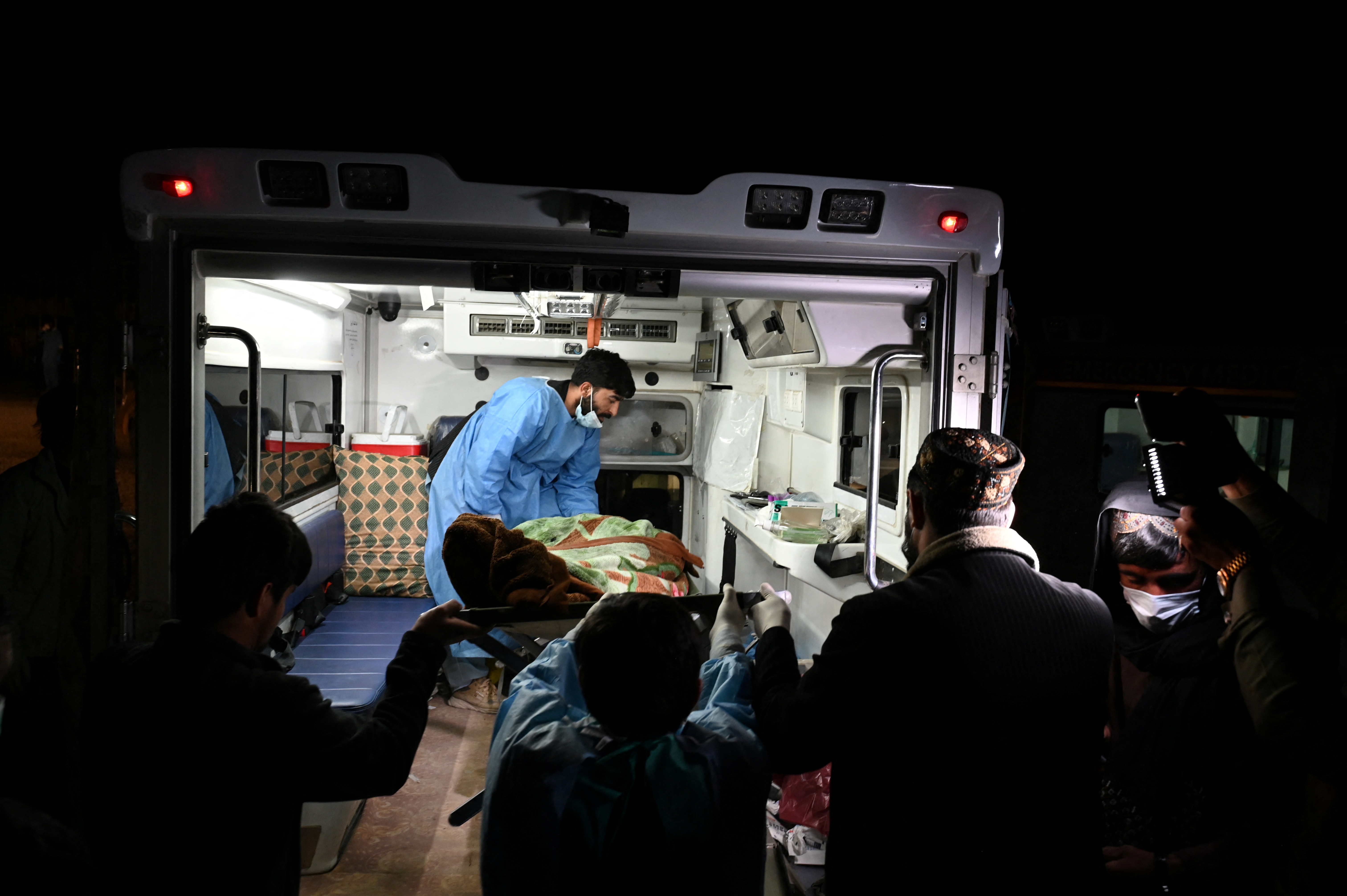 Afghan medical staff load a dead body onto an ambulance after Pakistani airstrikes allegedly hit the Secondary Rehabilitation Services Centre in Kabul on March 16, 2026.