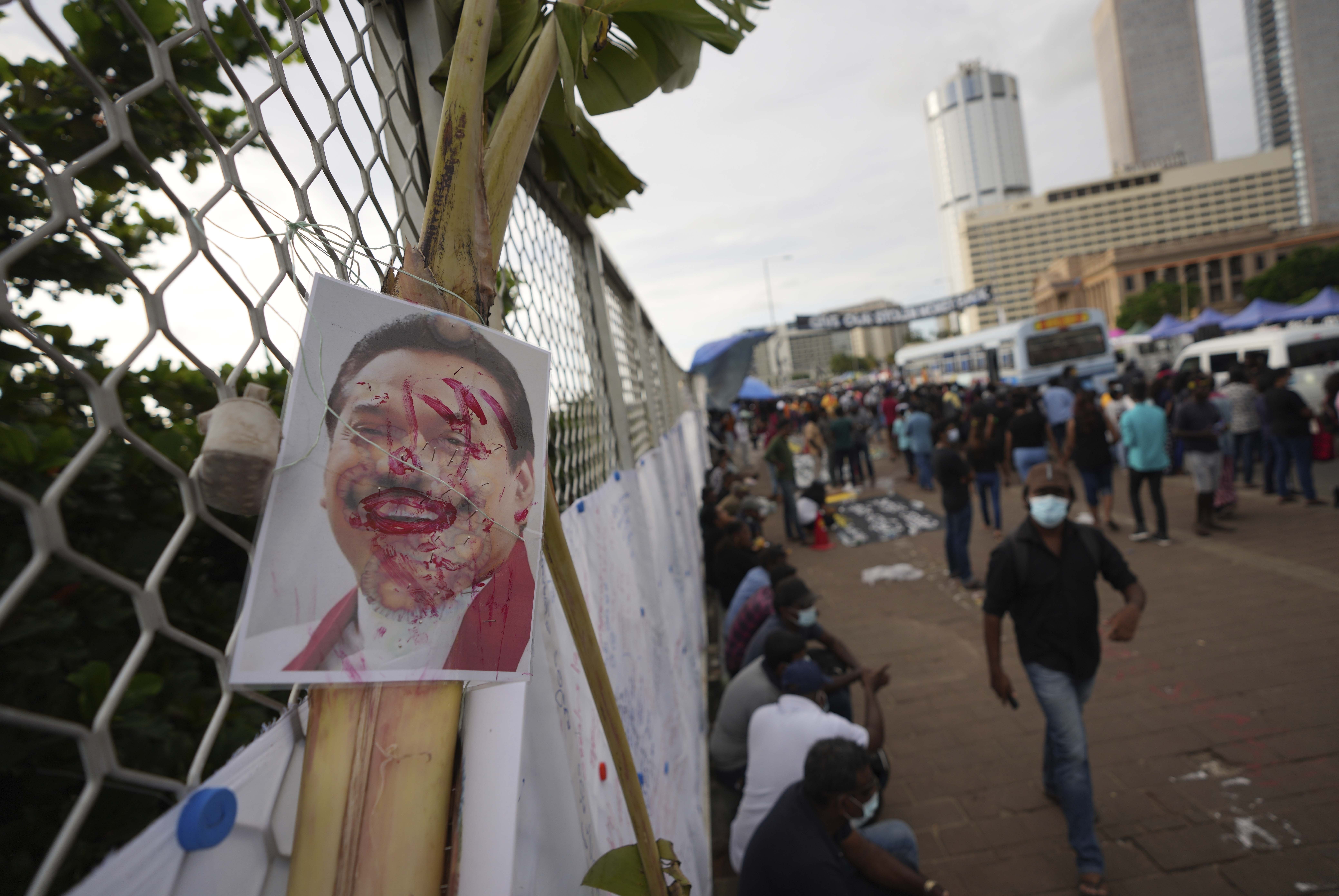 A vandalized portrait of Prime Minister Mahinda Rajapaksa is seen at a protest site outside President Gotabaya Rajapaksa's office in Colombo, Sri Lanka, Saturday, April 23, 2022. (AP Photo/Eranga Jayawardena, File)