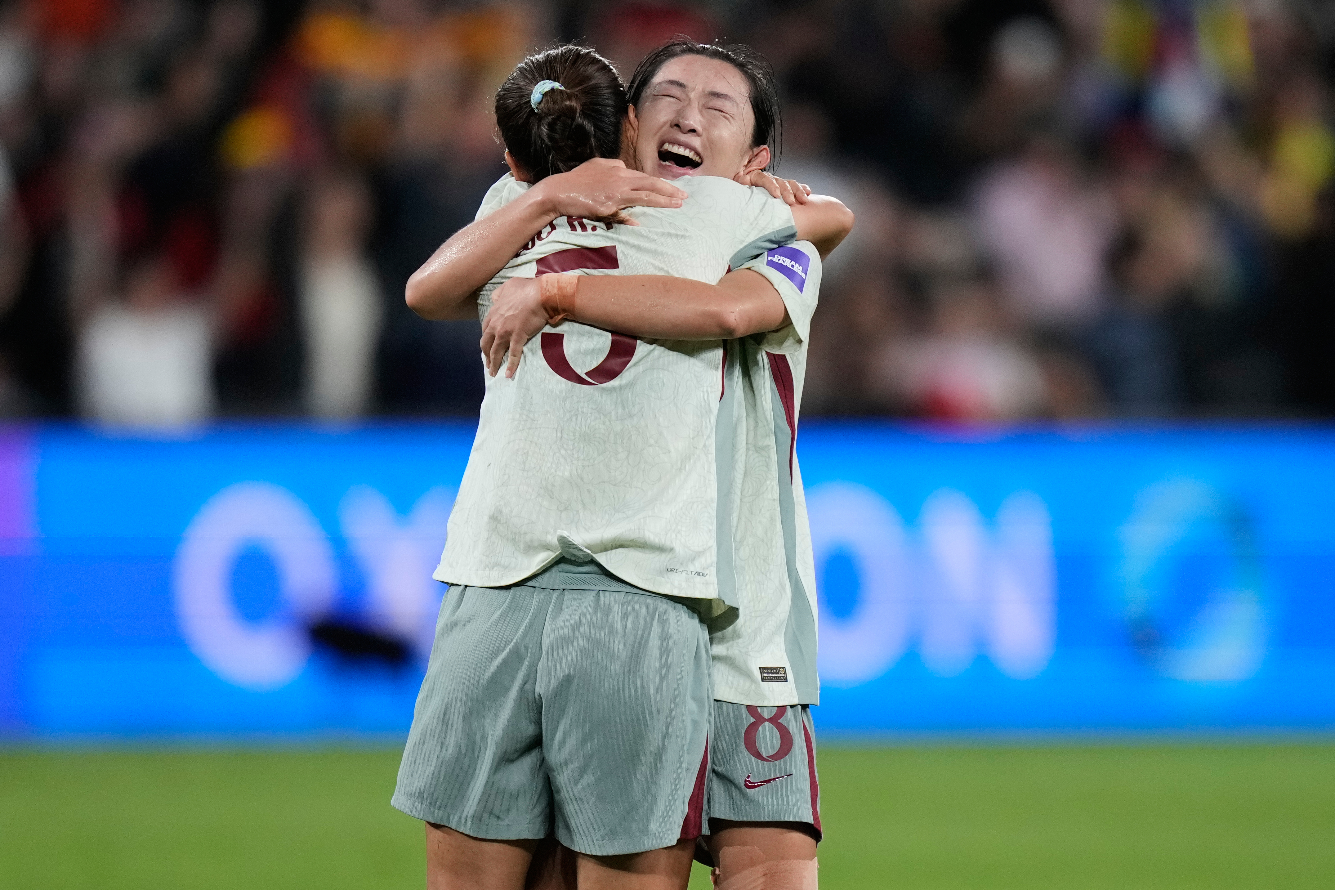 China's Yao Wei, right embraces teammate Wu Haiyan following the Women's Asian Cup