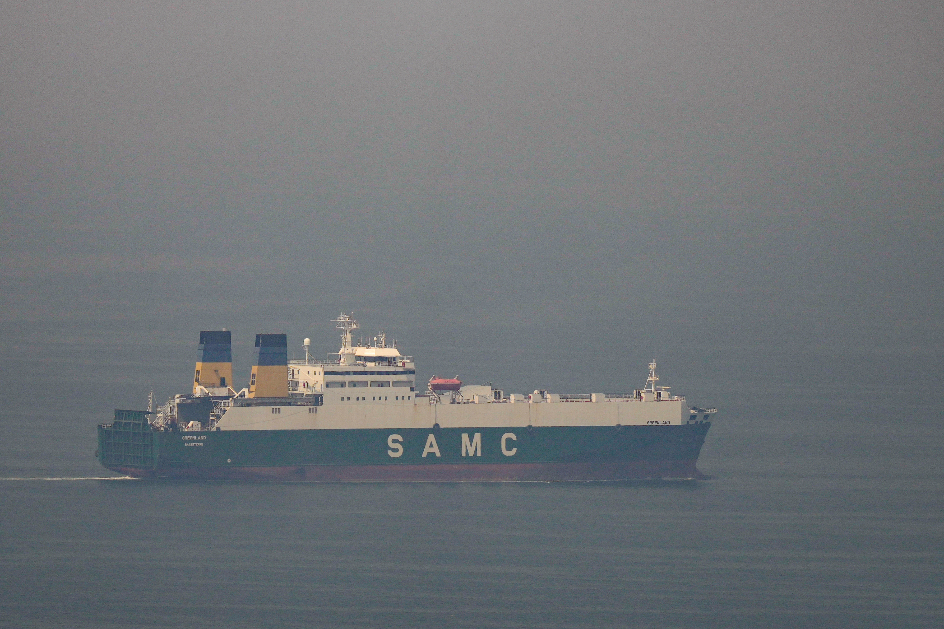 A cargo ship sails in the Gulf towards the Strait of Hormuz on March 15, 2026