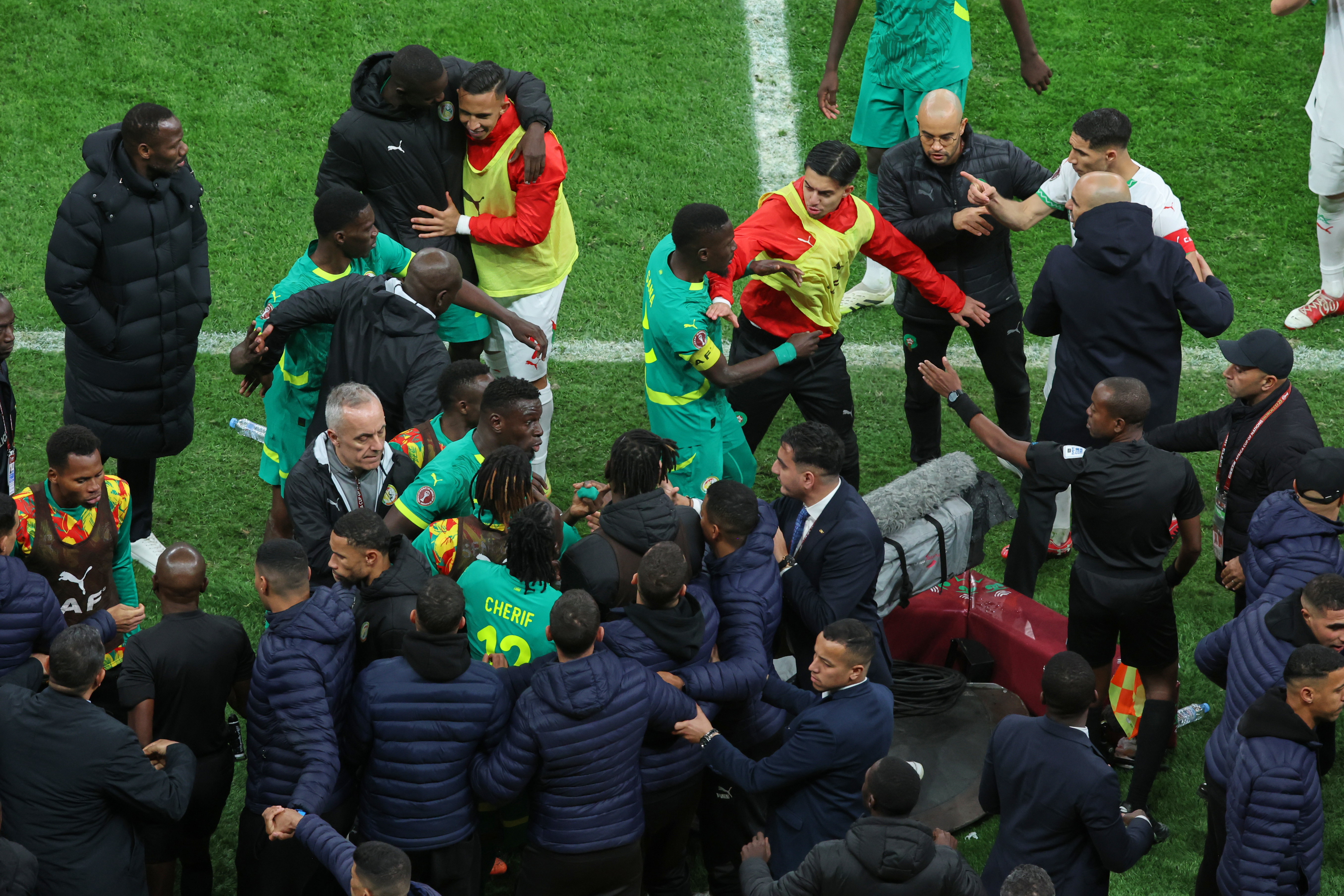 Players from both sides clash after a controversial penalty was awarded to Morocco late on during the Africa Cup of Nations final football match between Senegal and Morocco