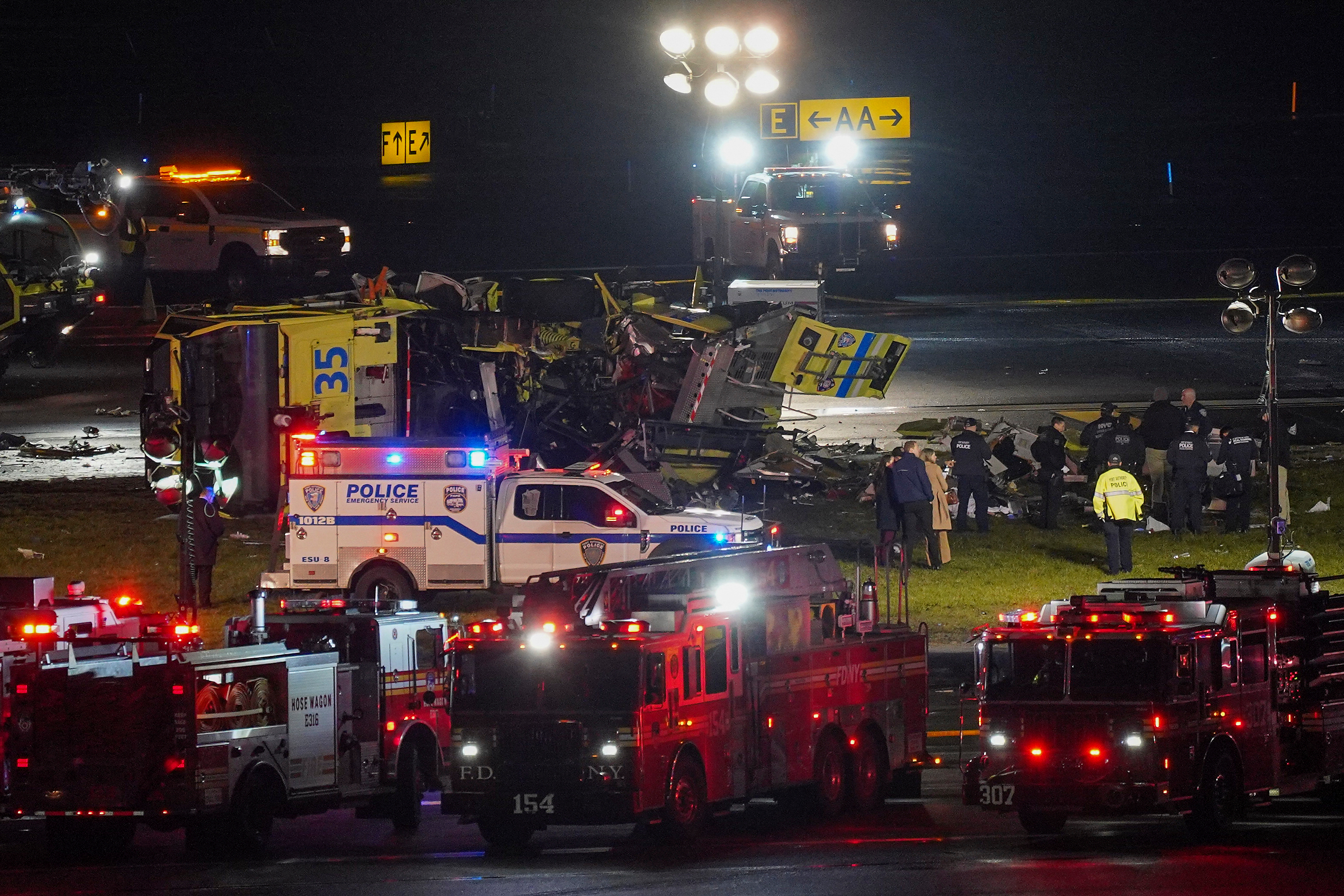 A Port Authority aircraft rescue and firefighting vehicle lays on its side off of runway 4 after colliding with an Air Canada jet after it landed at LaGuardia Airport, Monday