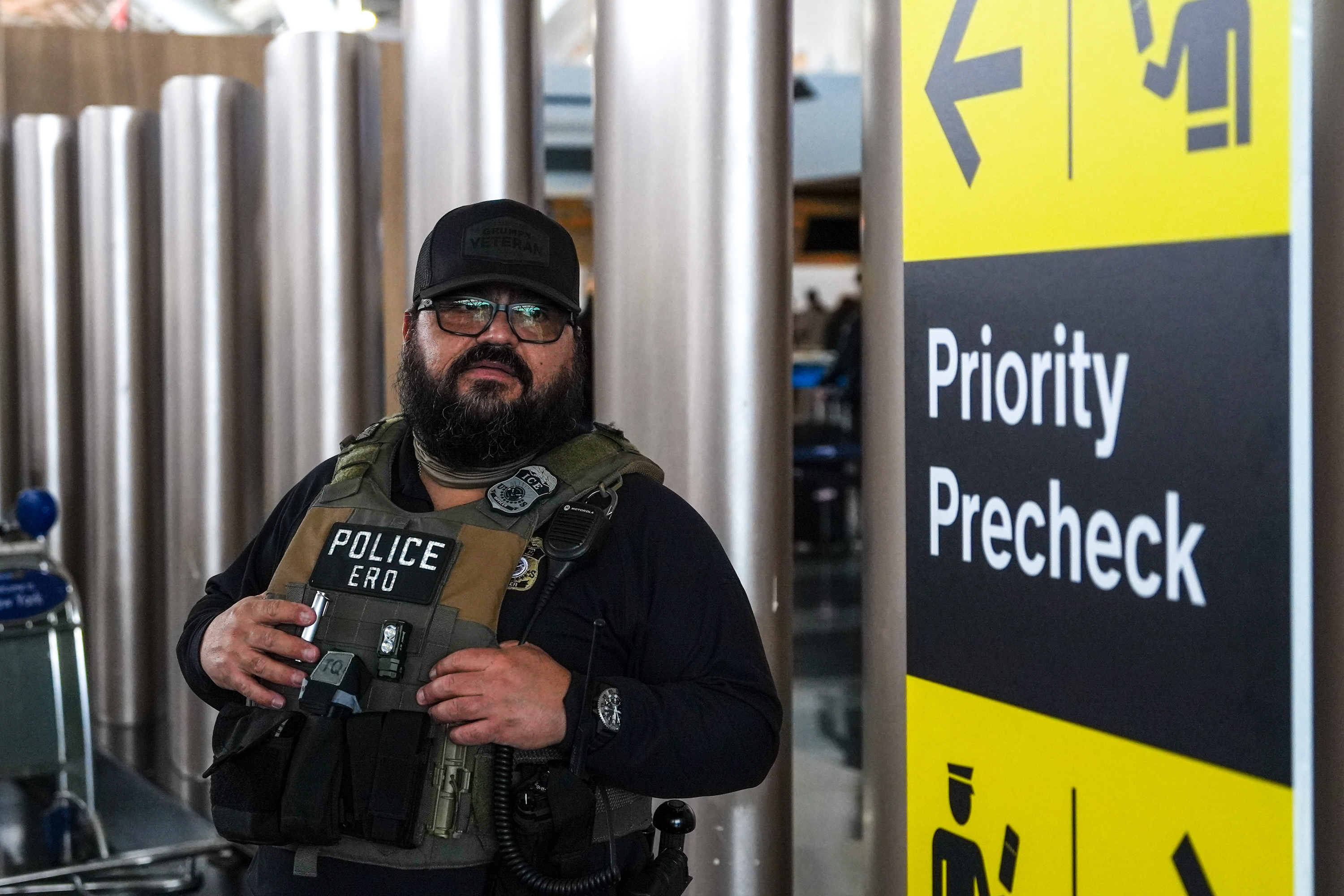 A federal immigration agent patrols John F. Kennedy International Airport (JFK) in the Queens borough of New York,