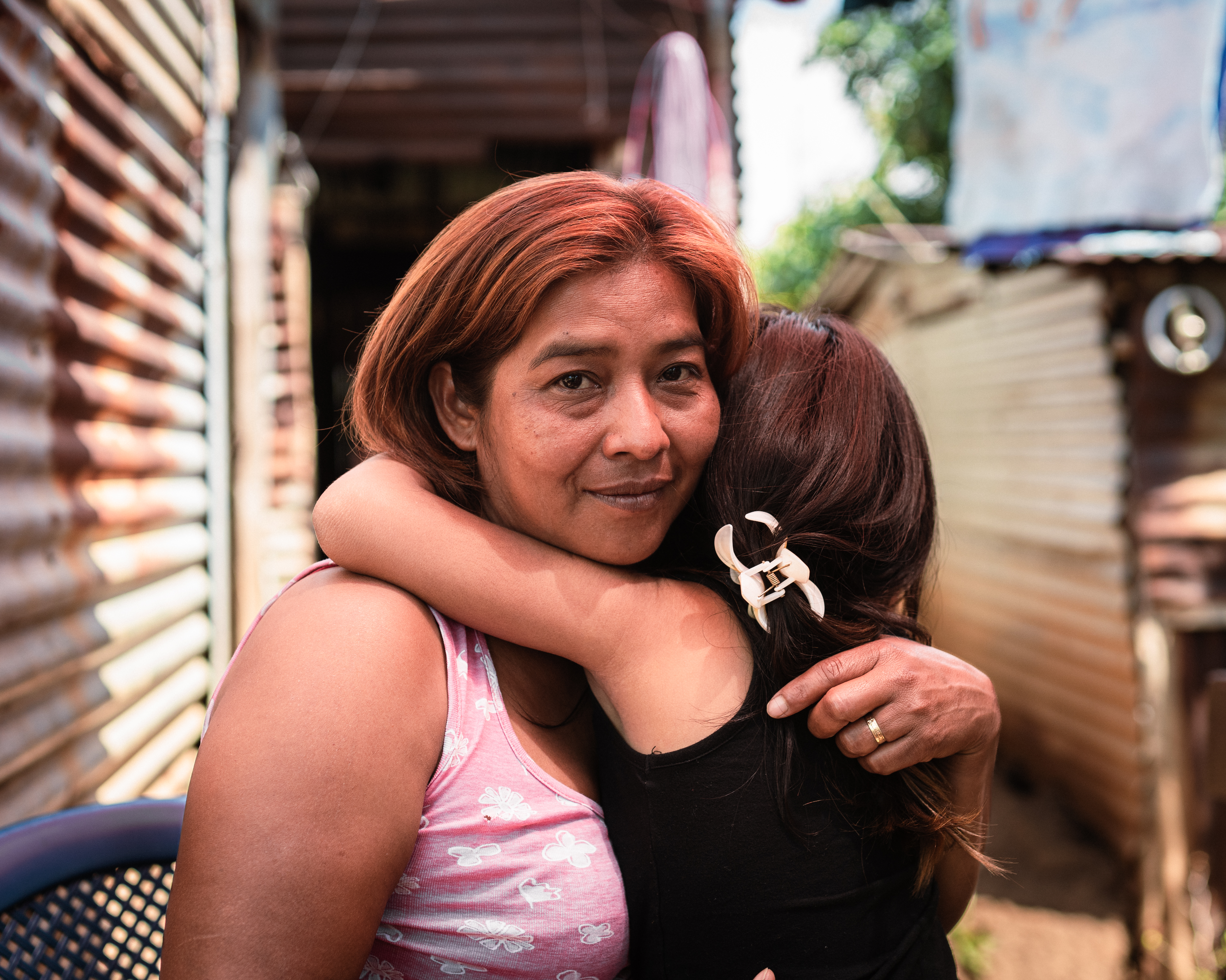 Rubidia Hernández and her 6-year-old granddaughter pictured in their home, where her son also used to live, in the outskirts ofNahuizalco, El Salvador. [Euan Wallace/ Al Jazeera]