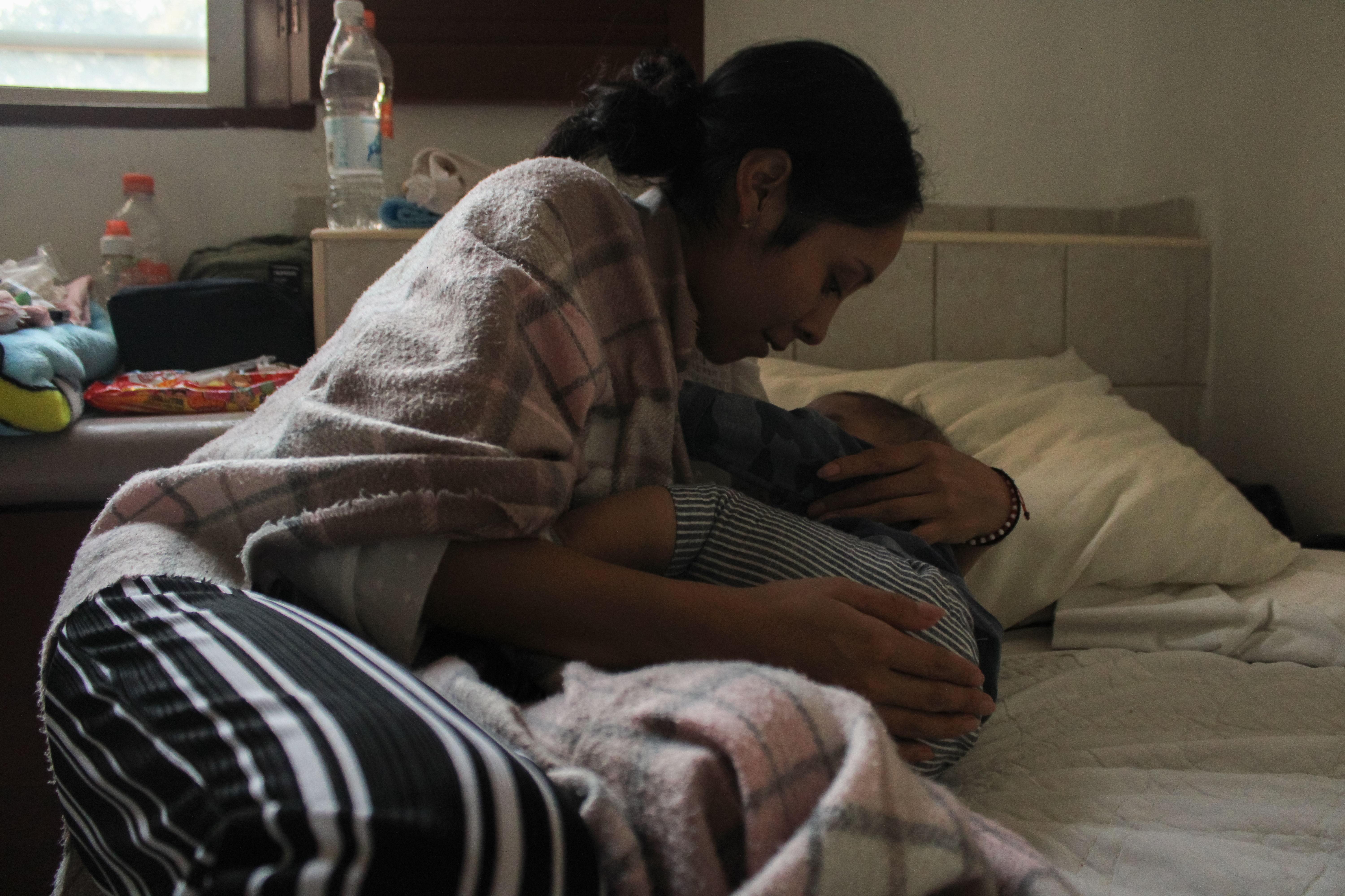 Luisa puts Juan de Jesús to bed in their room at the shelter_-1-1773831284