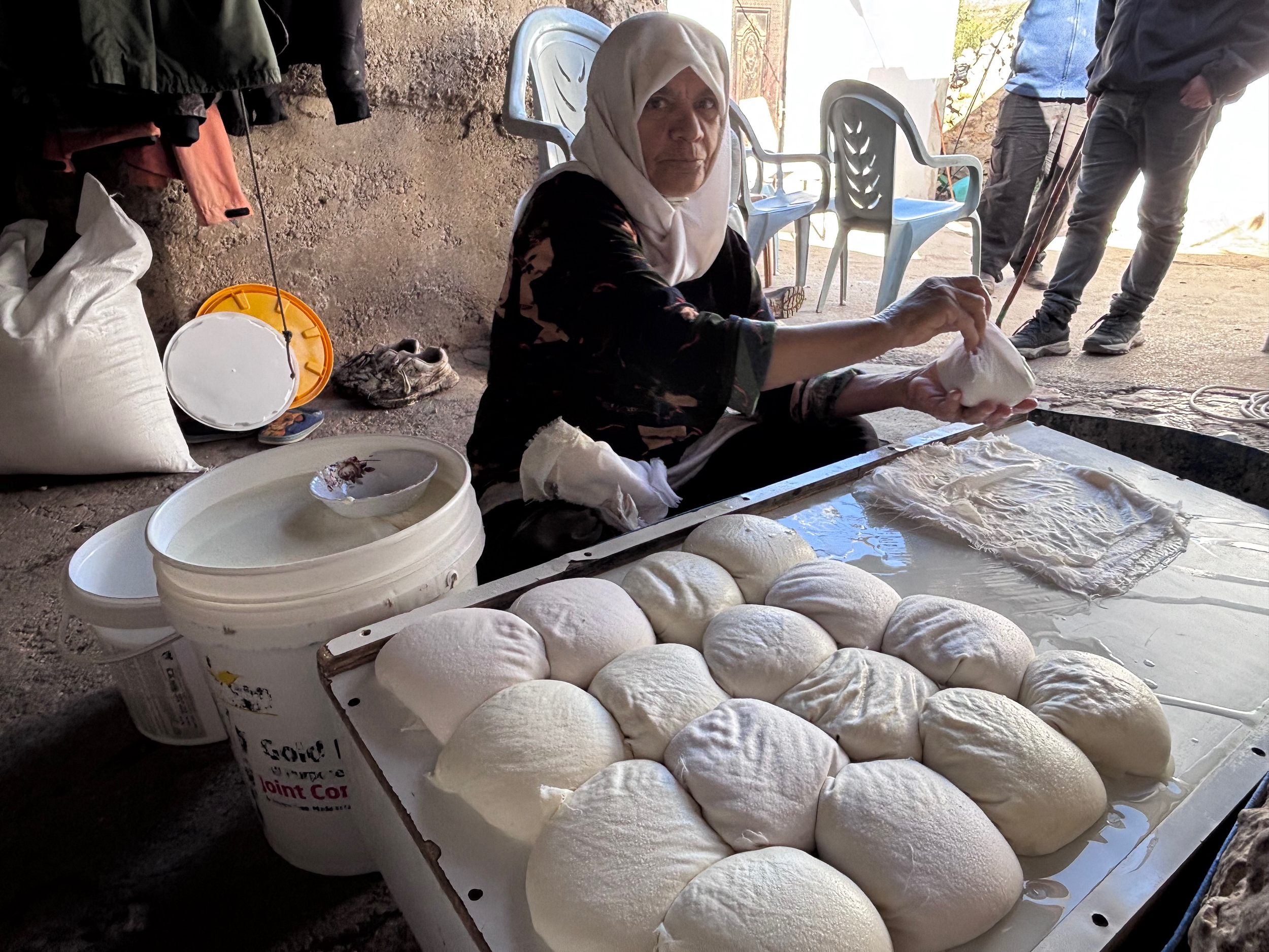 Hajja Latifa prepares baladi cheese in the courtyard of the Masallam family home in Khirbet al-Marajim.