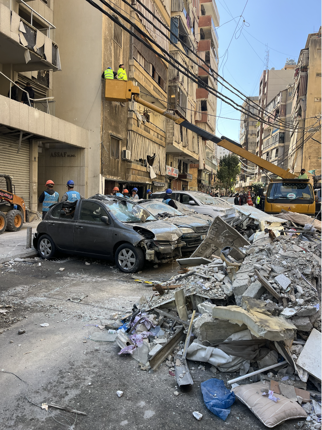 Damaged cars below the Israeli attack on Aisha Bakkar, Beirut. [Justin Salhani/Al Jazeera]