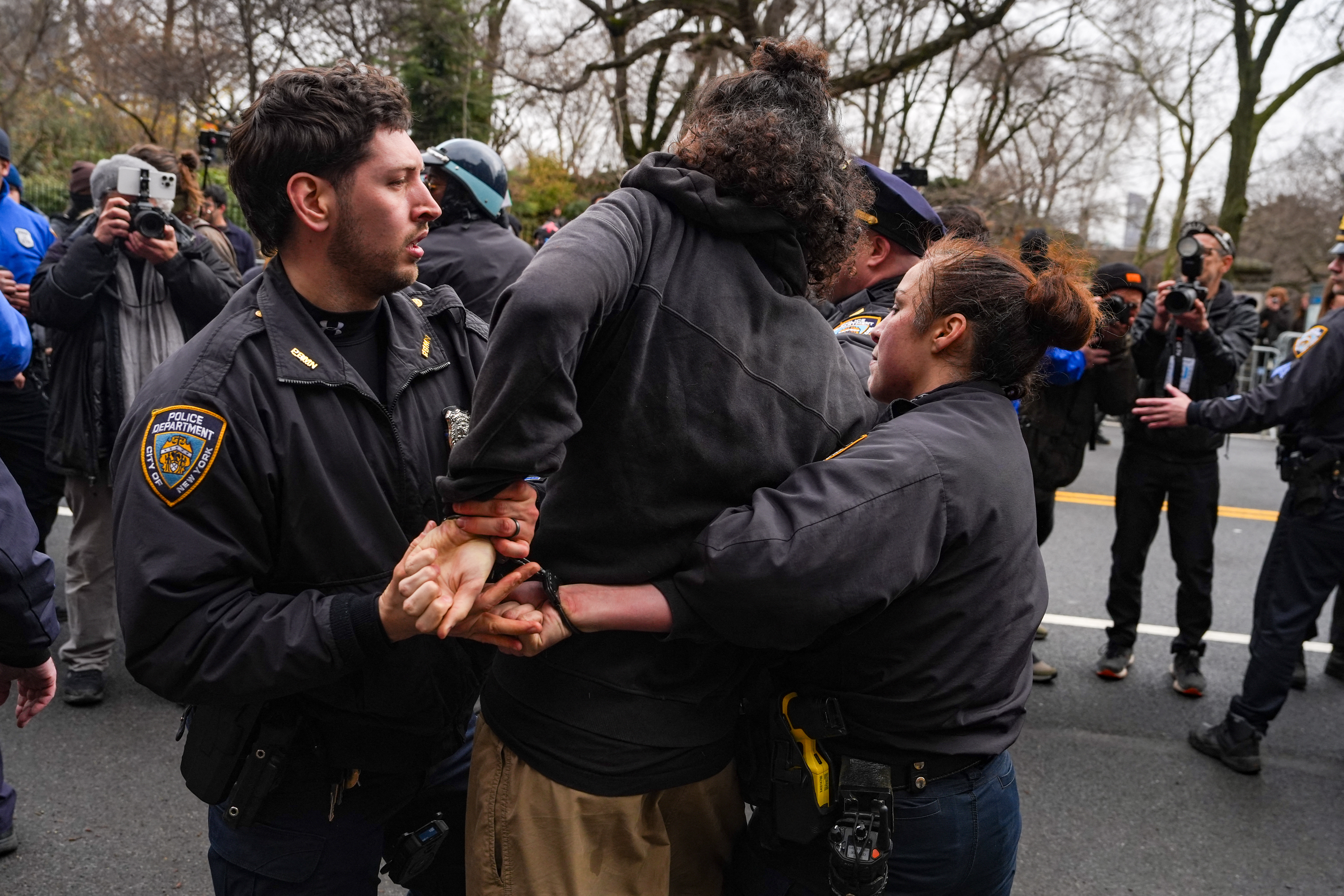 NEW YORK, NEW YORK - MARCH 7: A man is arrested after throwing a hand-made smoke grenade at right-wing activist Jake Lang and his supporters on March 7, 2026 in New York City. Lang is facing misdemeanor charges in D.C. Superior Court for making threatening statements to a police officer. Ryan Murphy/Getty Images/AFP (Photo by RYAN MURPHY / GETTY IMAGES NORTH AMERICA / Getty Images via AFP)