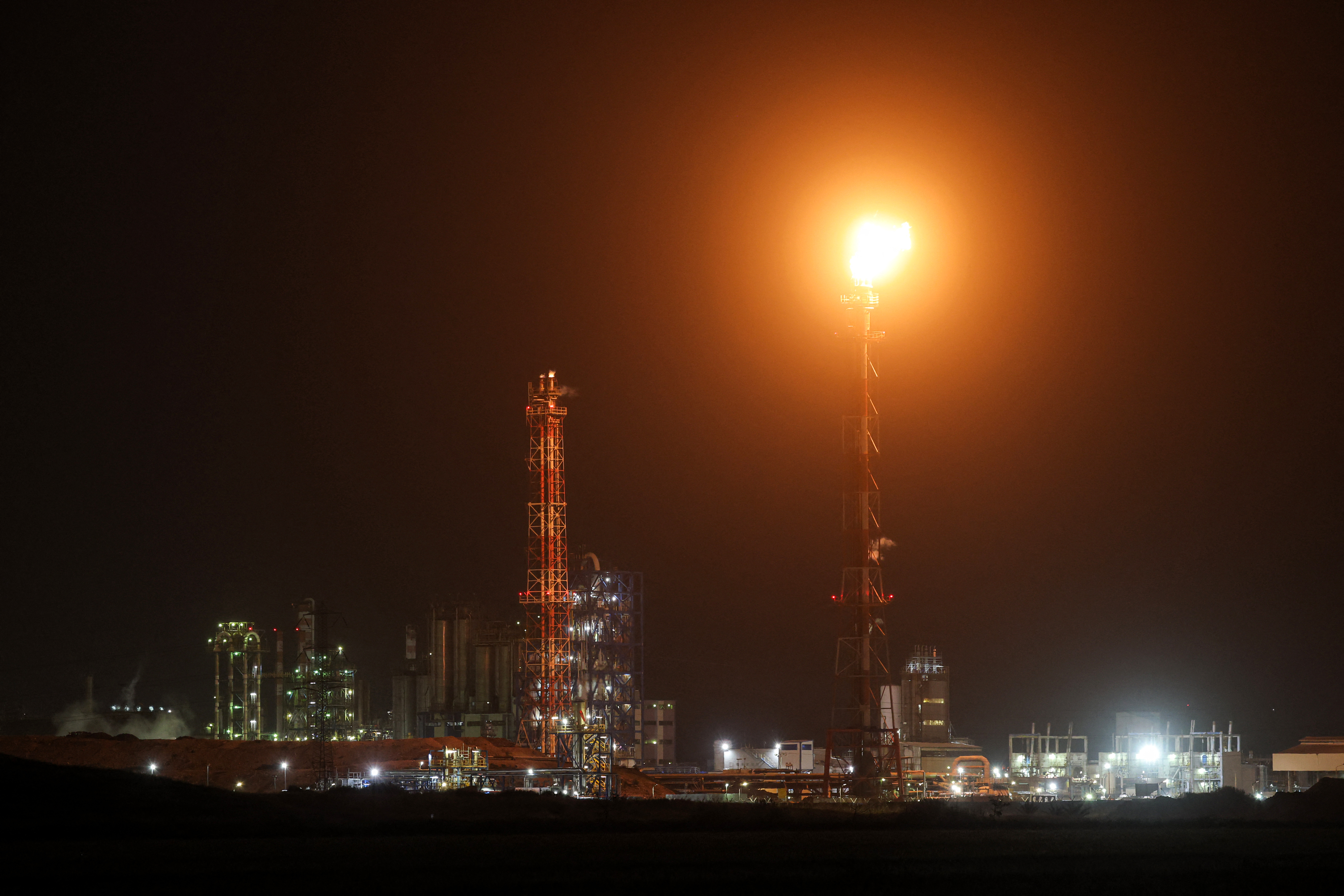 TOPSHOT - Excess gas is burned at the oil refinery in Israel's northern city of Haifa late on March 19, 2026.